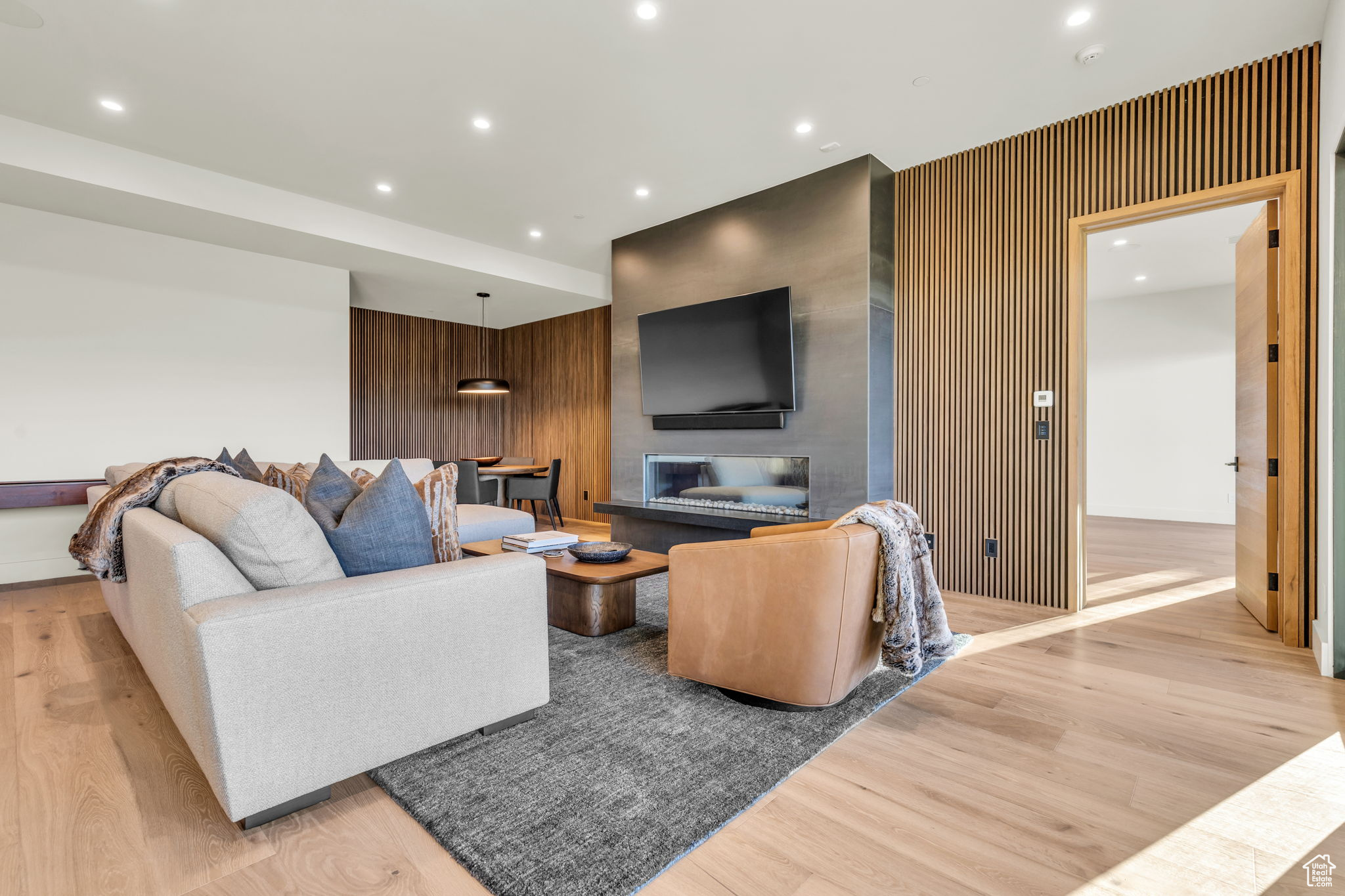 Living room featuring wood walls and light wood-type flooring