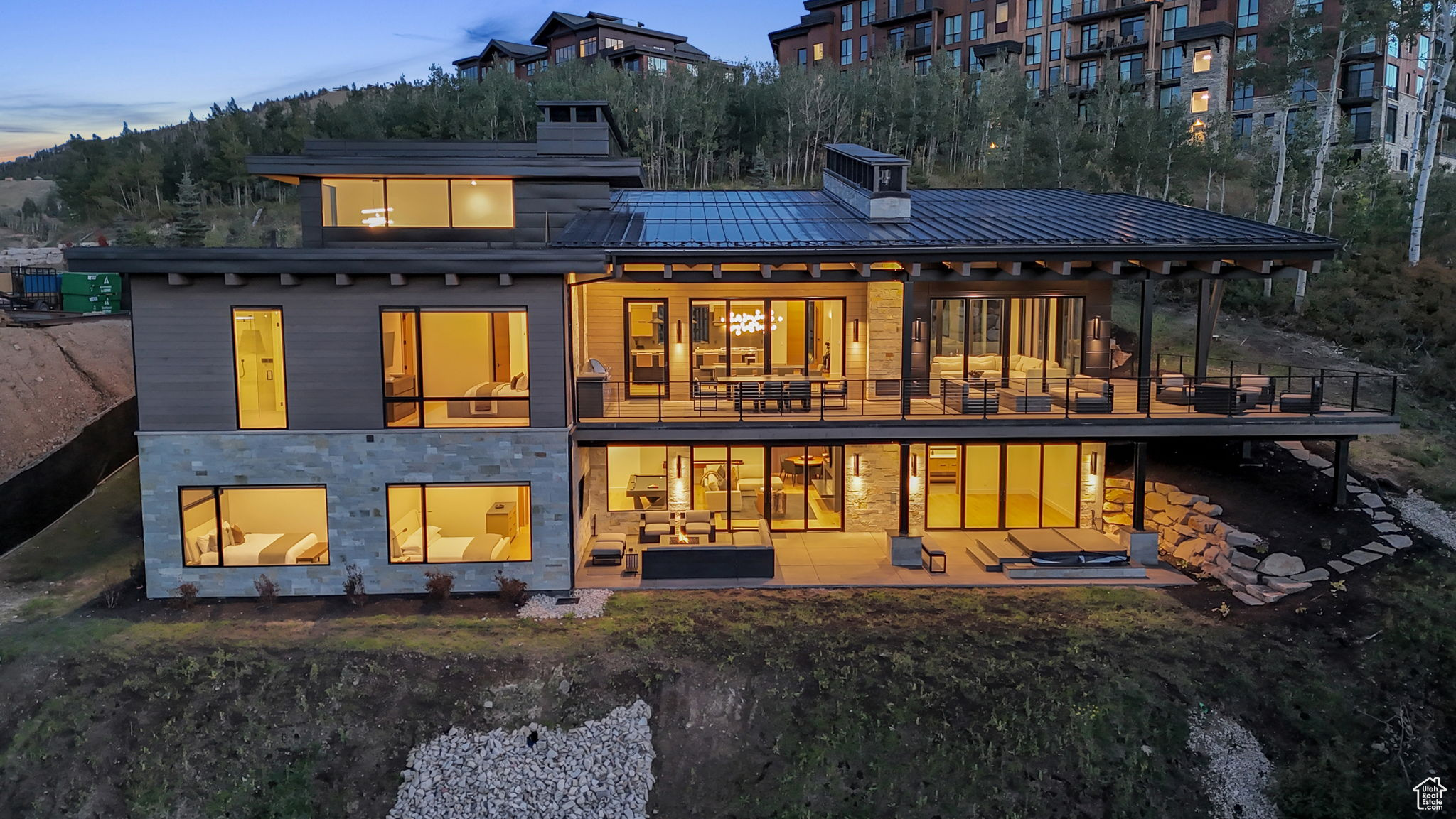 Back house at dusk with a patio area and an outdoor hangout area