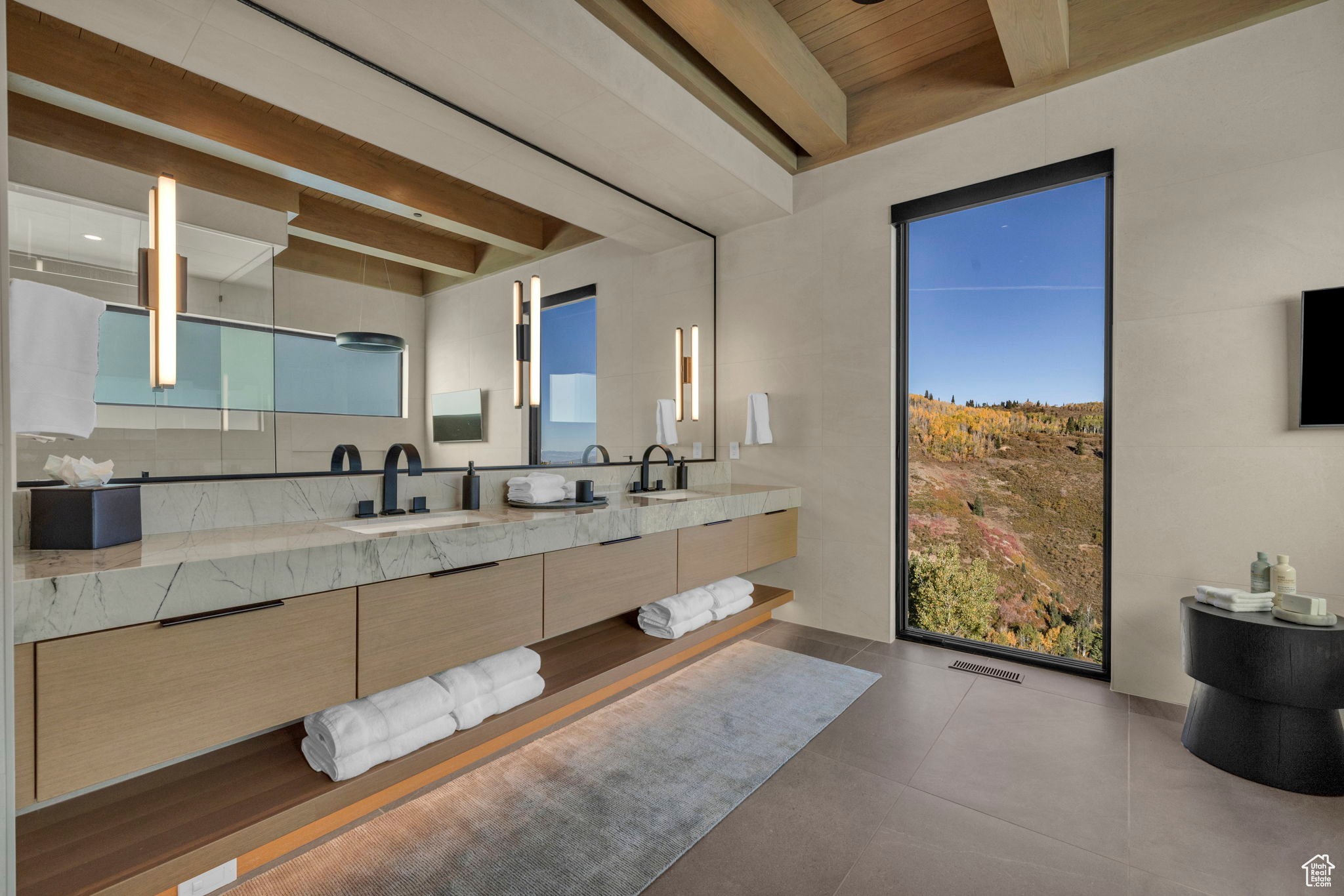 Bathroom with beamed ceiling, vanity, and tile patterned flooring