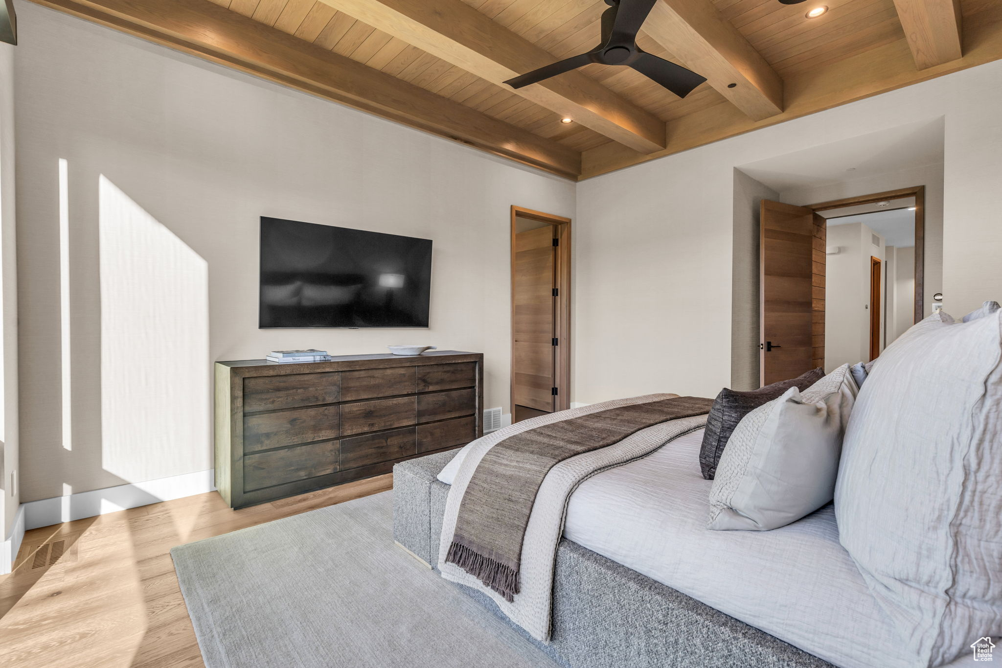 Bedroom featuring ceiling fan, beamed ceiling, wood ceiling, and light wood-type flooring