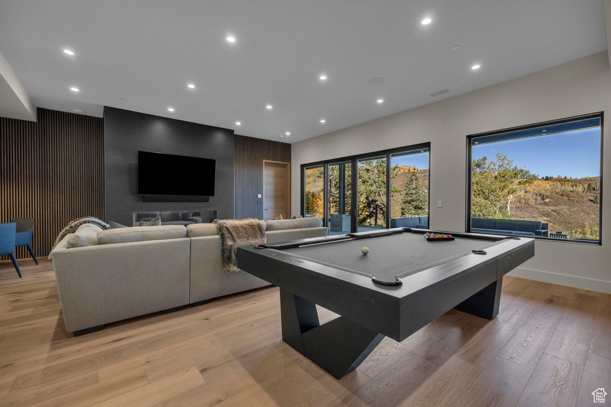 Game room with light wood-type flooring and pool table