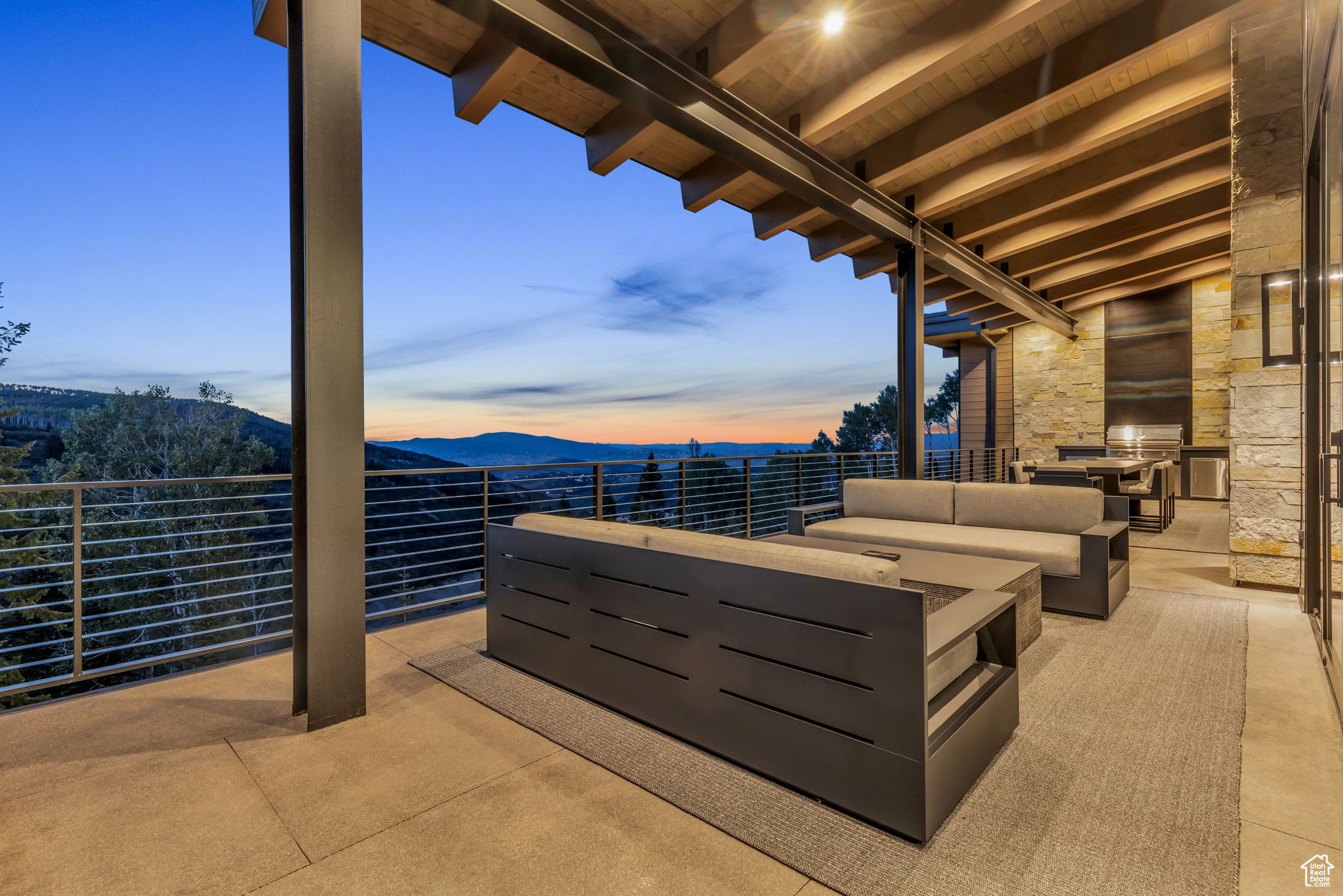 Patio terrace at dusk featuring a mountain view and an outdoor hangout area