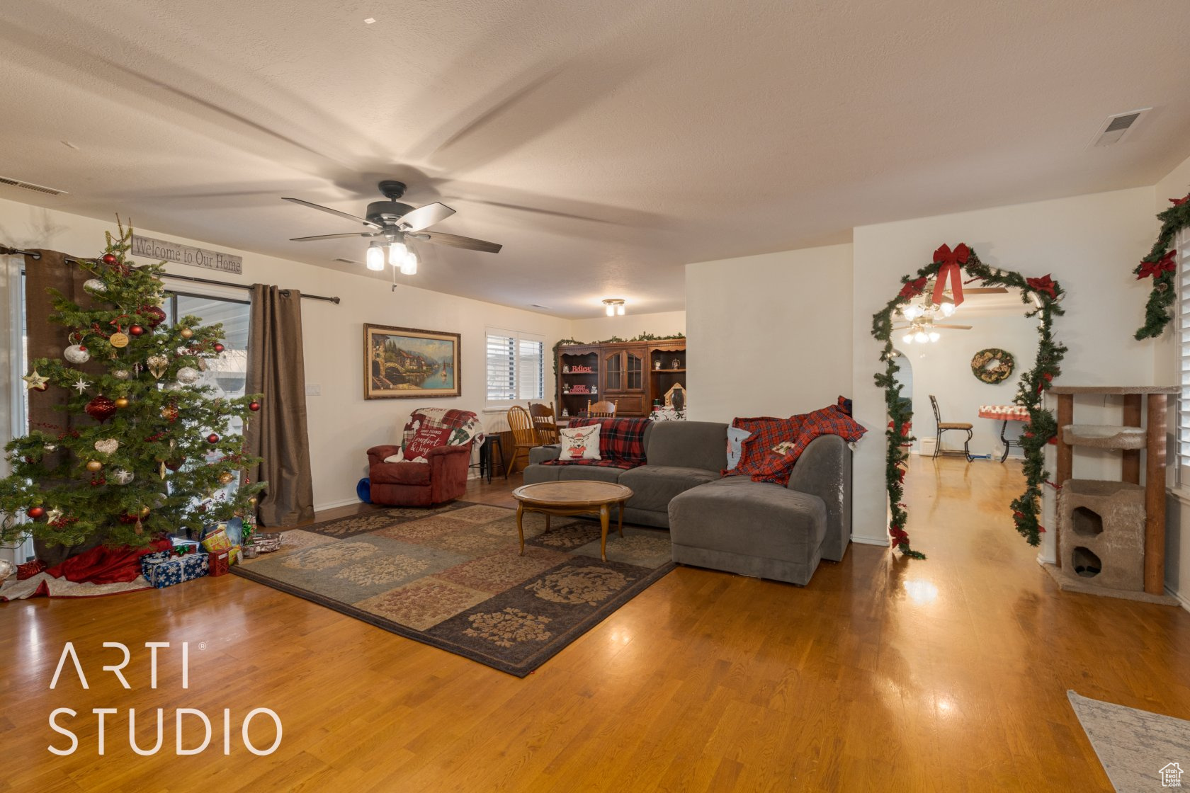 Living room with wood-type flooring and ceiling fan