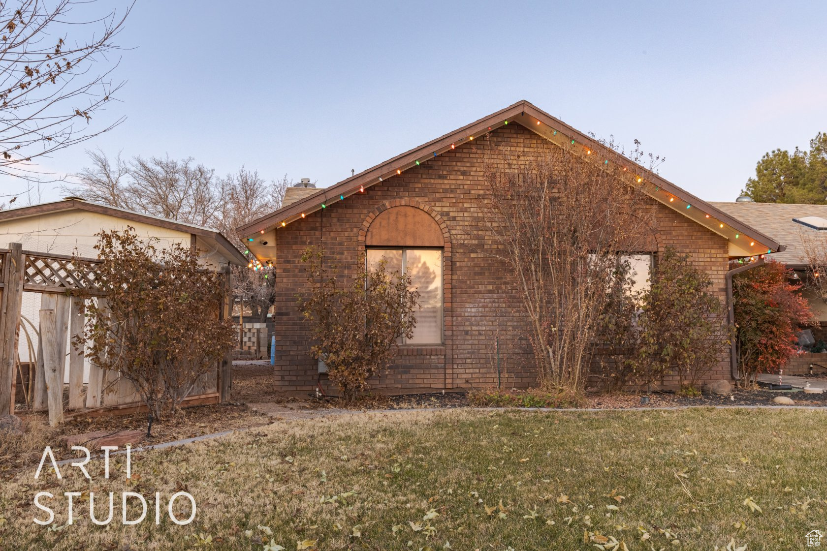 View of side of home featuring a yard