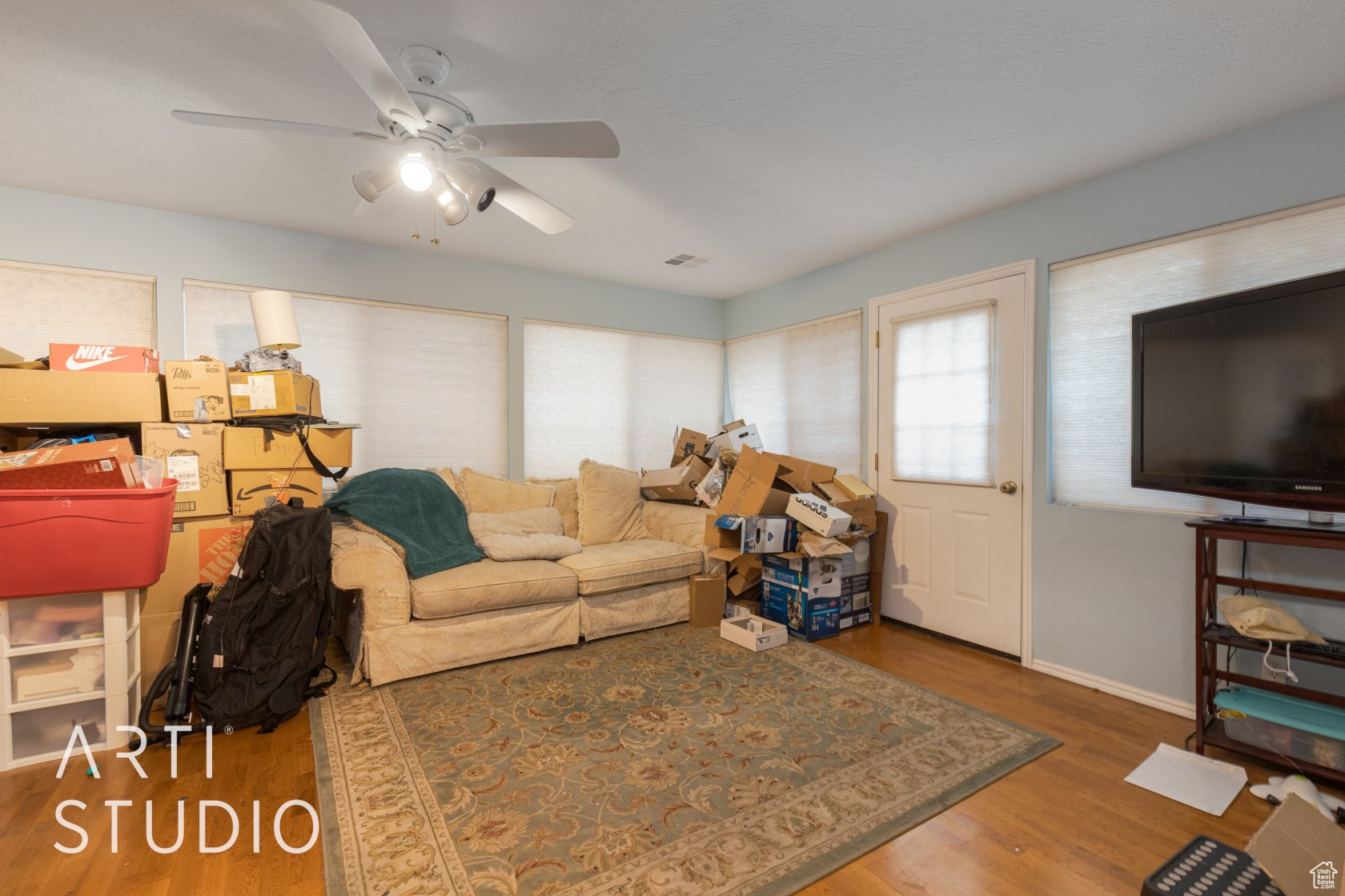 Living room with hardwood / wood-style flooring and ceiling fan