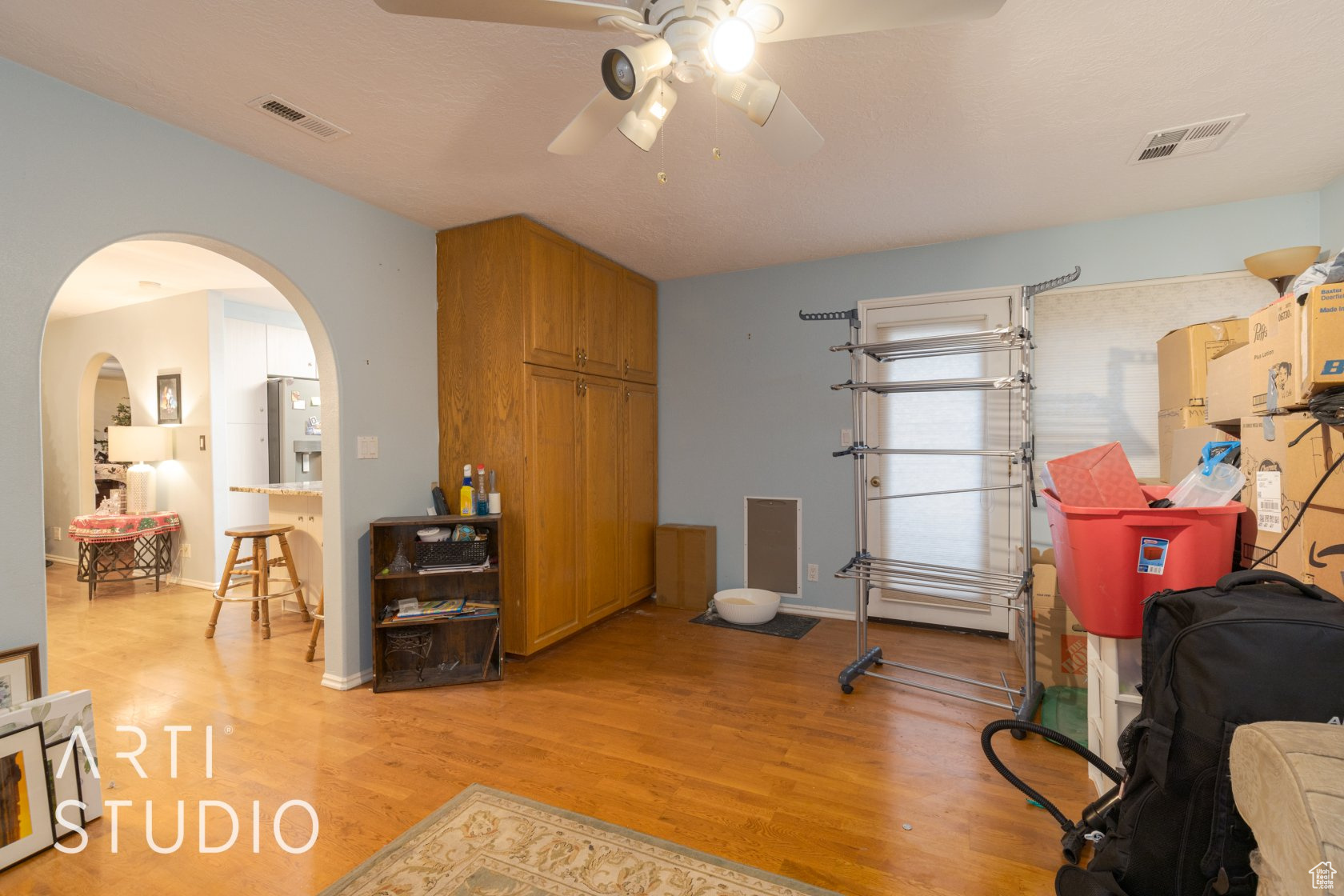 Interior space with ceiling fan and light hardwood / wood-style floors