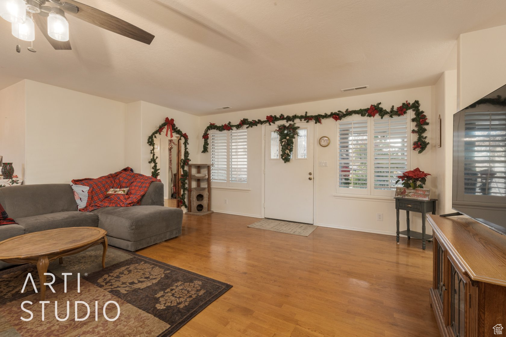 Living room featuring hardwood / wood-style floors and ceiling fan