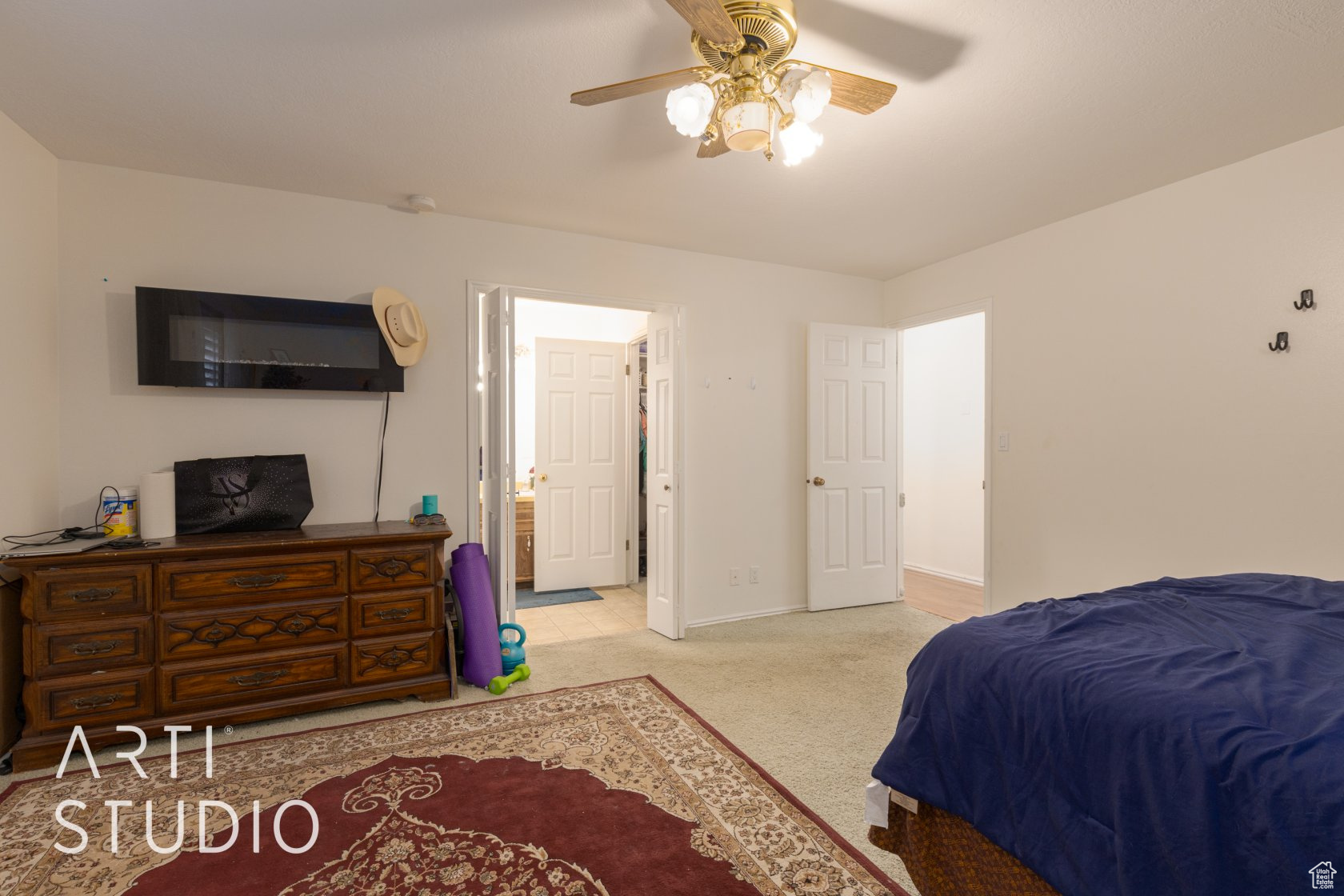 Carpeted bedroom with ceiling fan