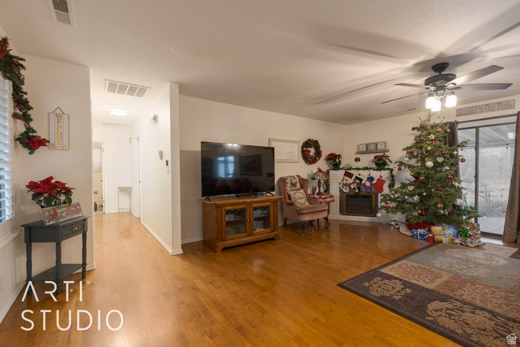 Living room with hardwood / wood-style floors and ceiling fan