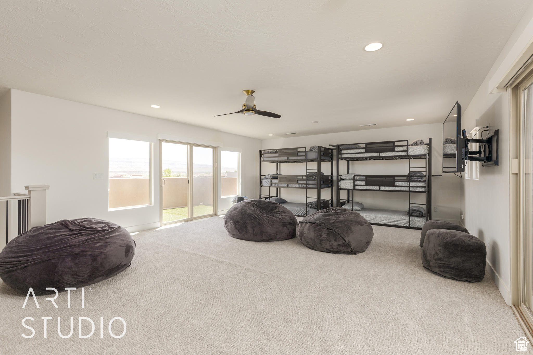 Interior space featuring carpet flooring, ceiling fan, and two decks