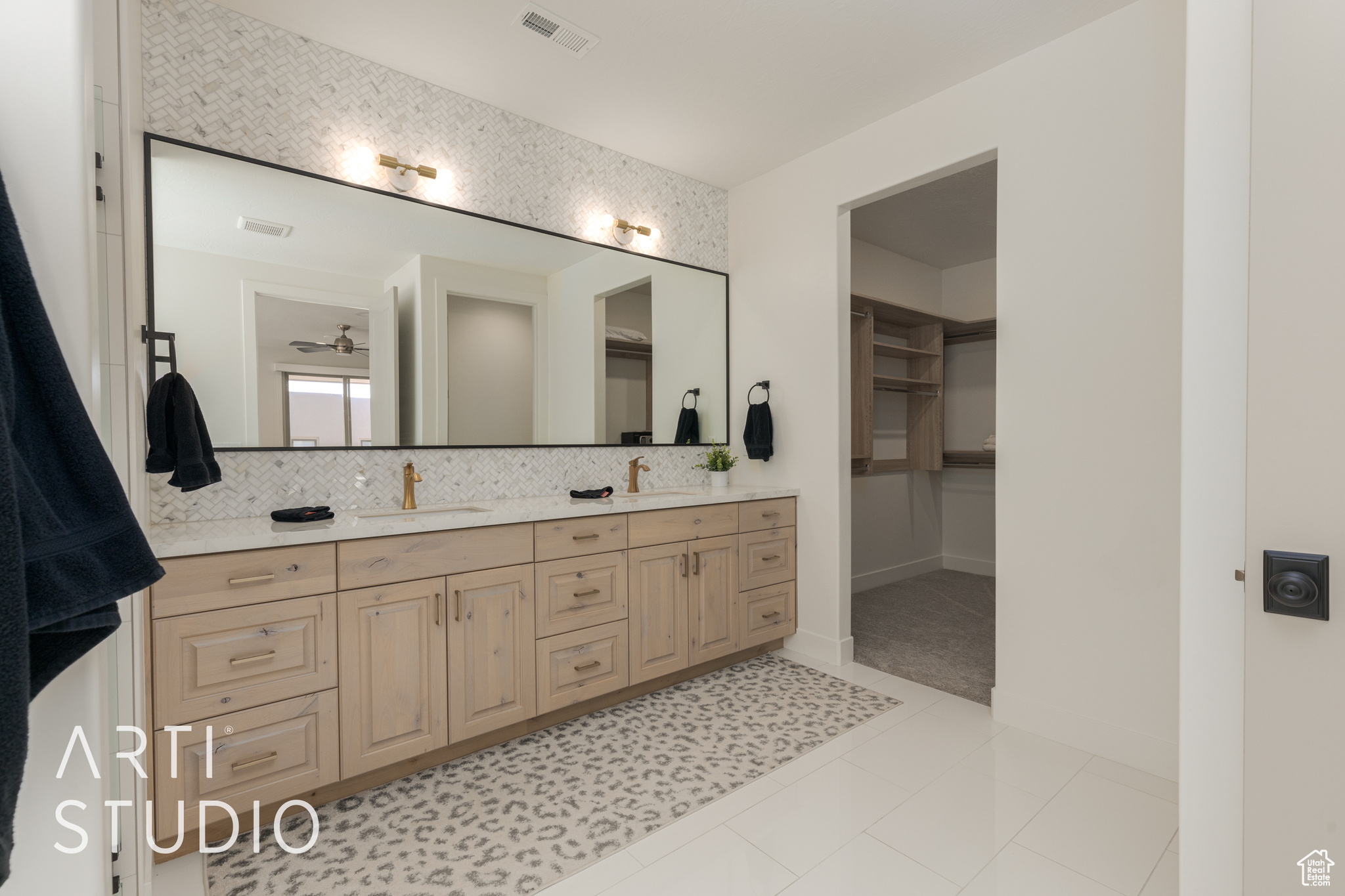 Primary Bathroom with backsplash, tile flooring, and vanity