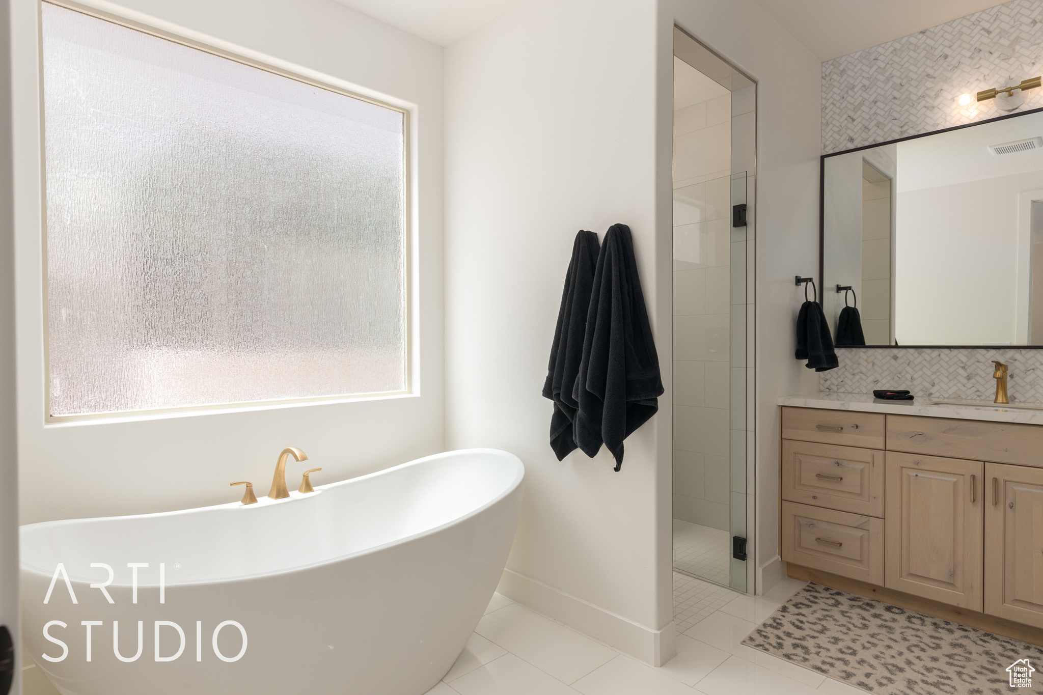 Primary Bathroom with tile floors, vanity, separate shower and tub, and a healthy amount of sunlight