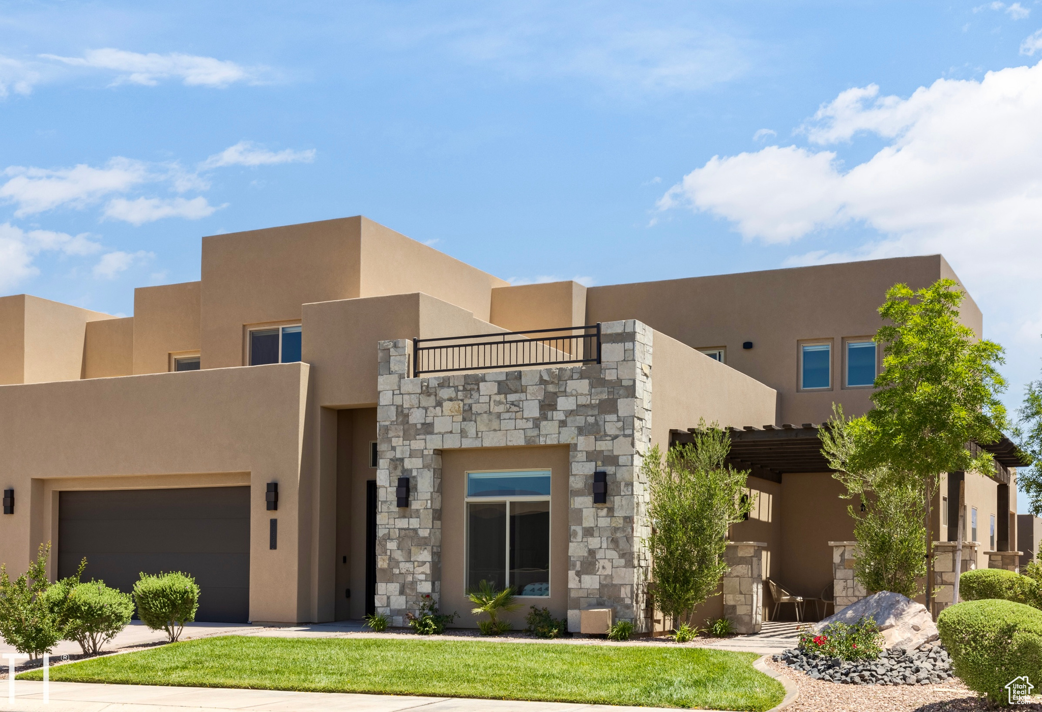 Pueblo-style home featuring a garage