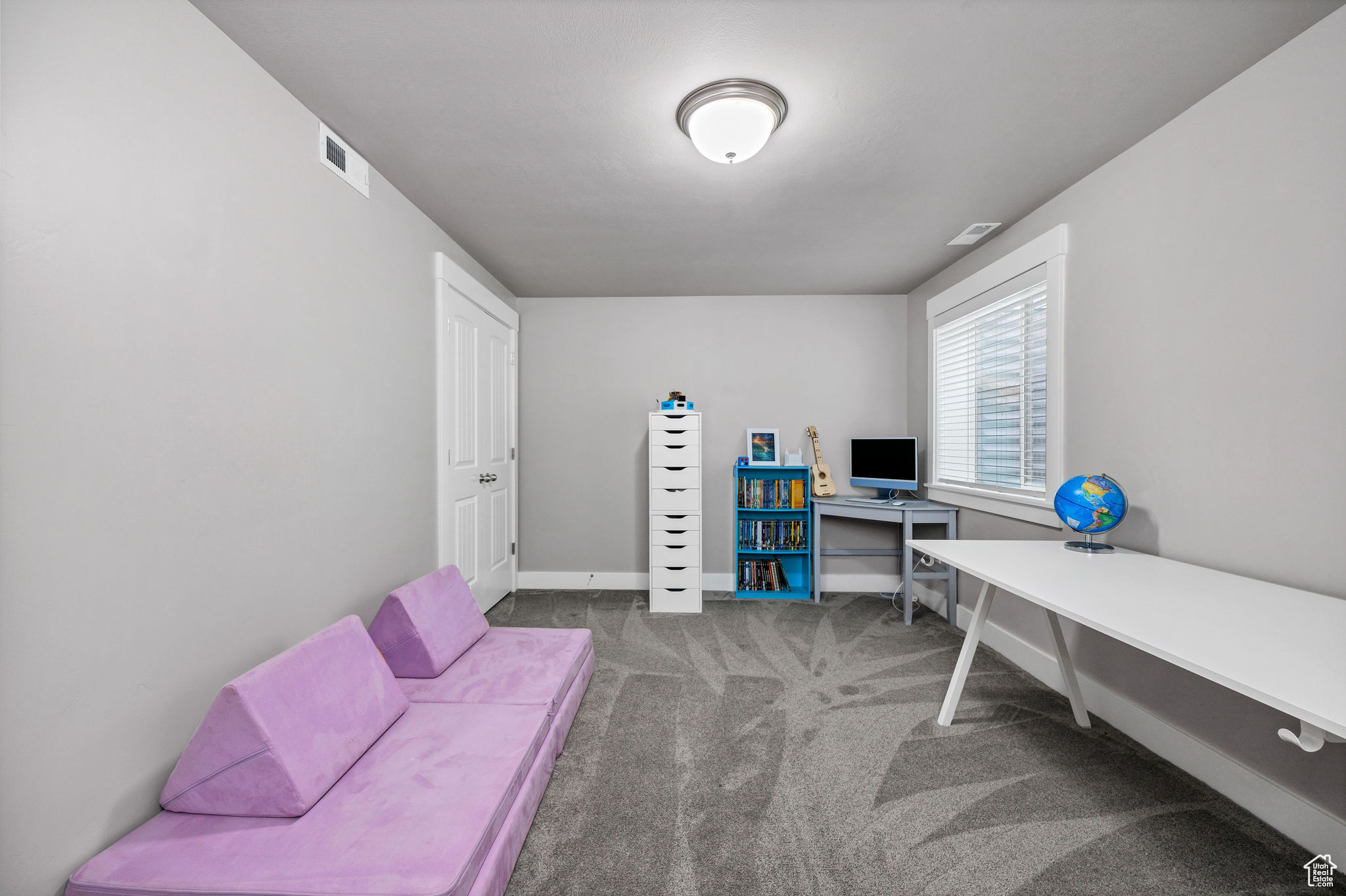 View of carpeted bedroom with closet