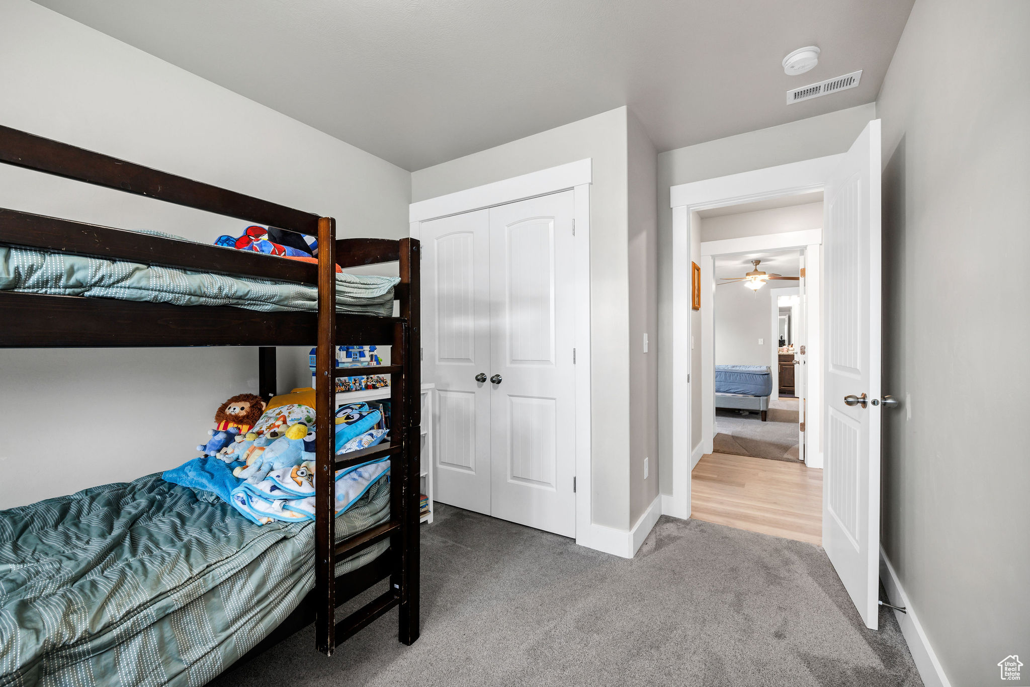 Carpeted bedroom with a closet