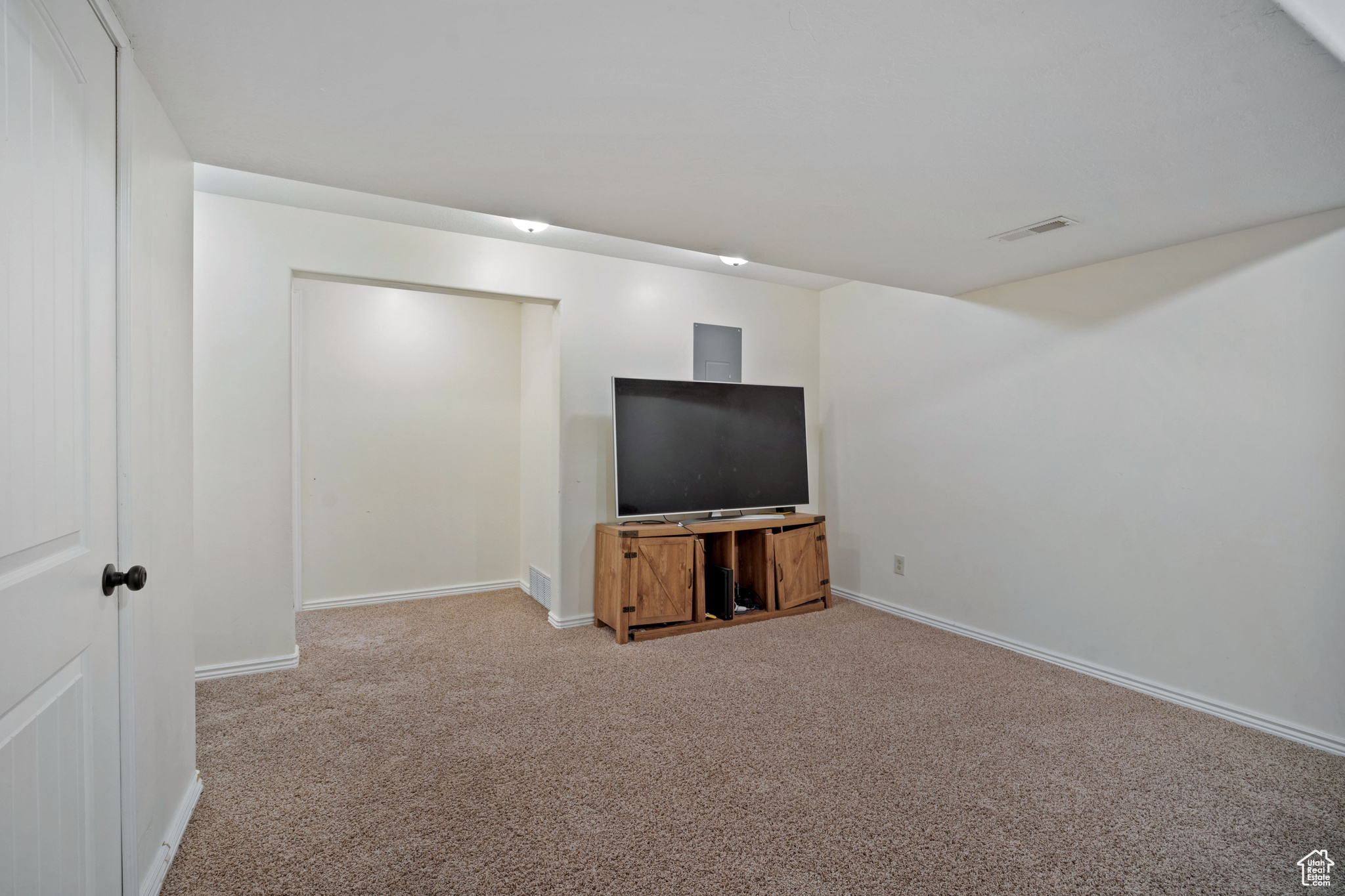 Unfurnished living room featuring carpet floors