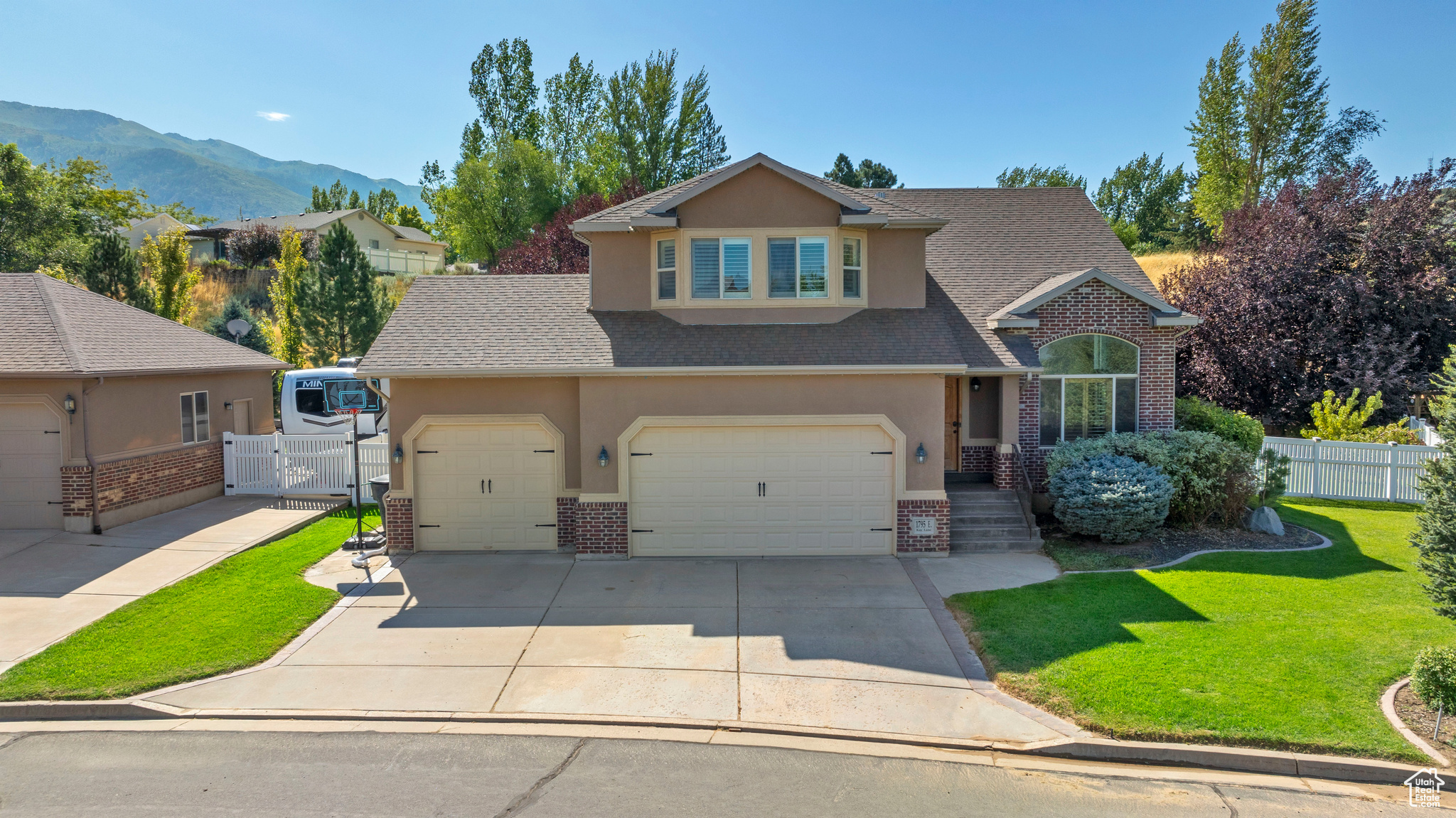 Front of property with a mountain view, a garage, and a front yard