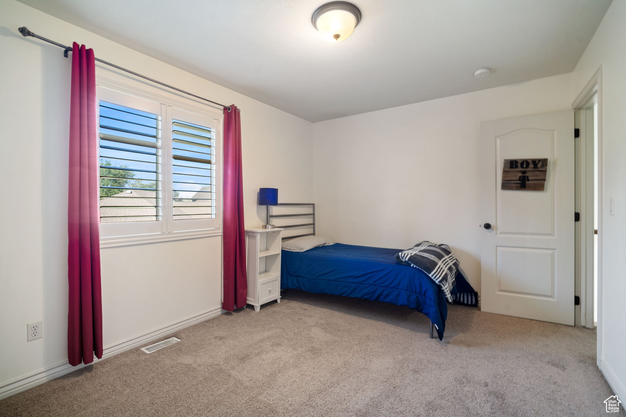 Bedroom with light colored carpet