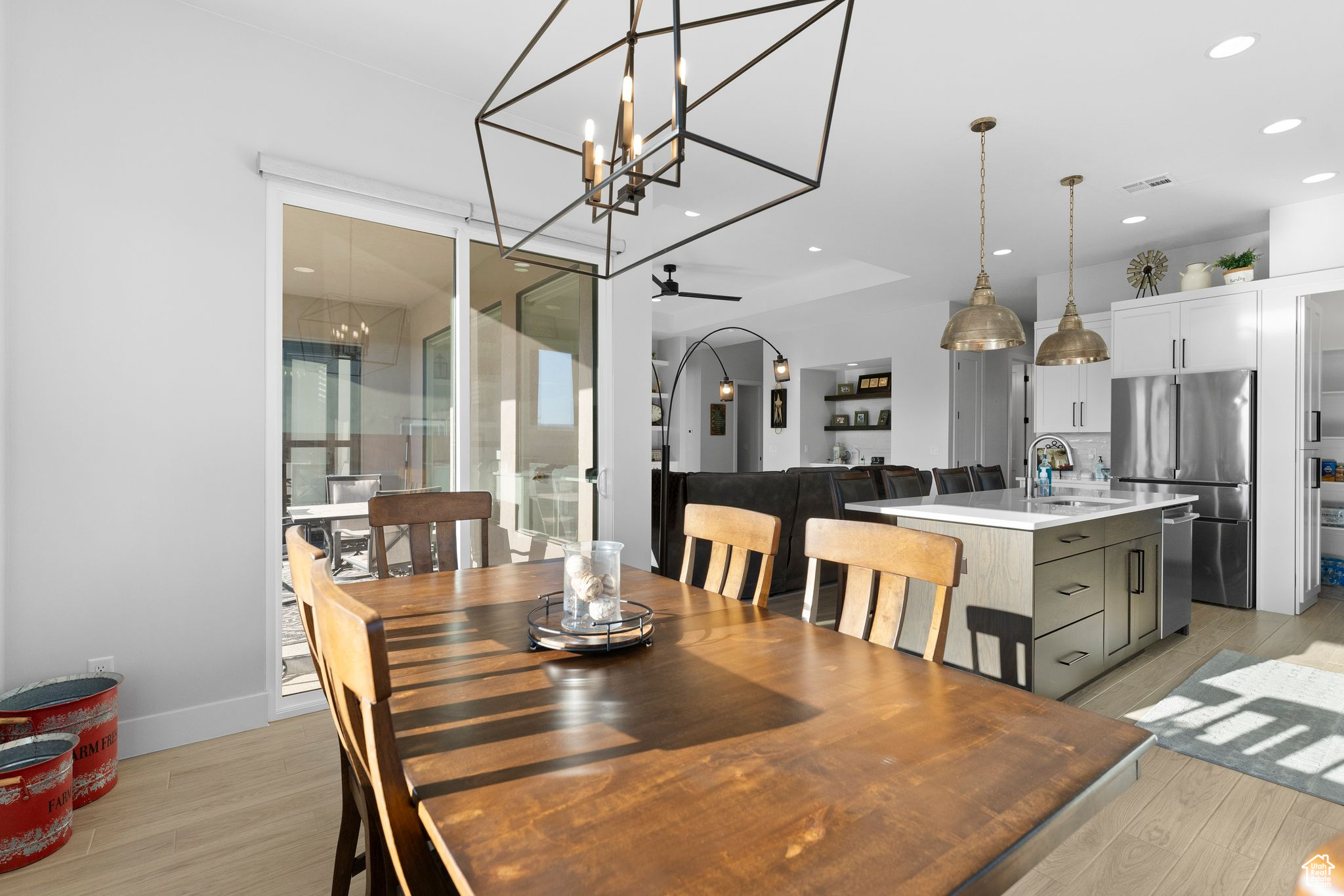 Dining room featuring ceiling fan with notable chandelier, light hardwood / wood-style floors