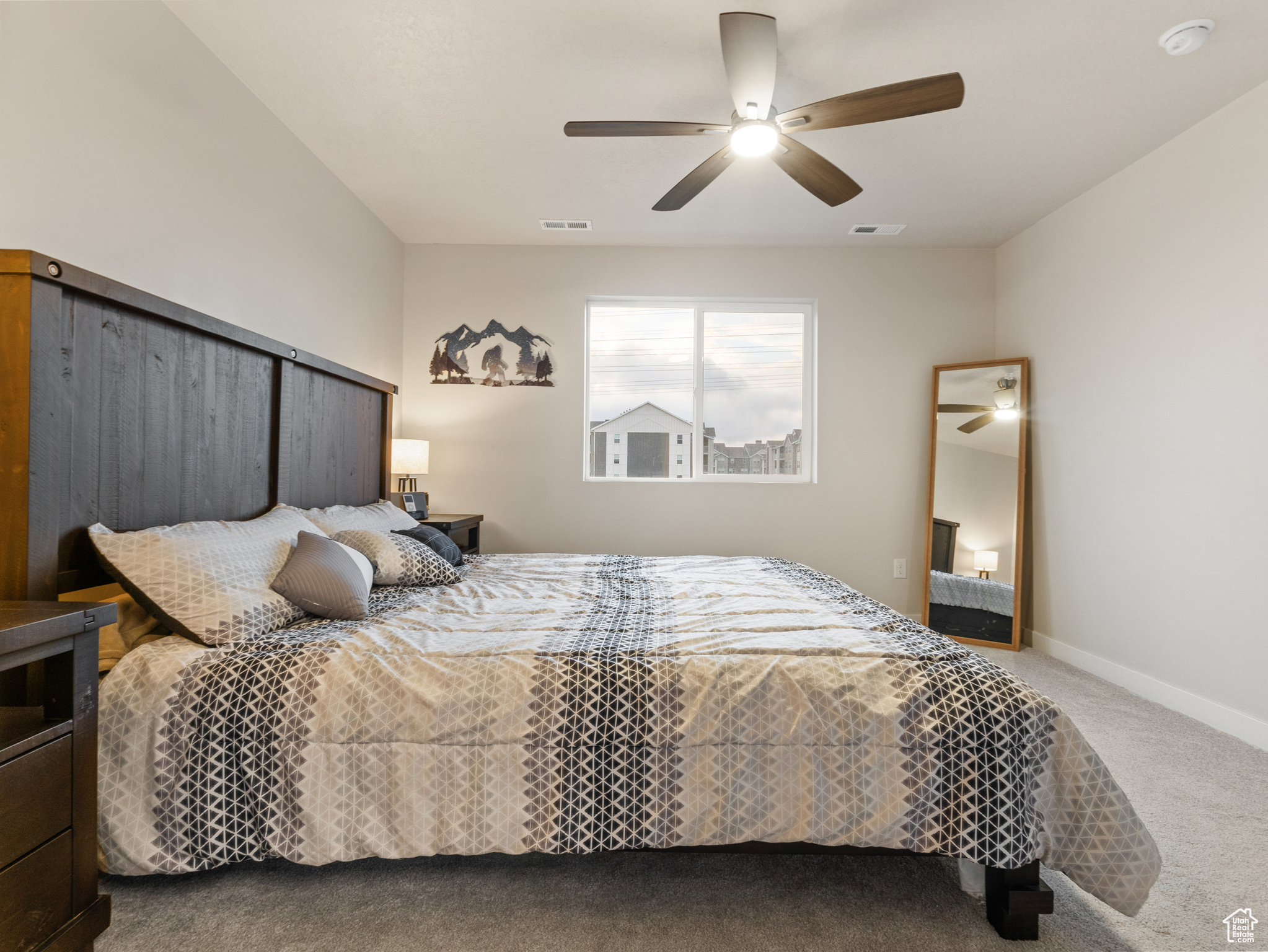 Carpeted bedroom with ceiling fan