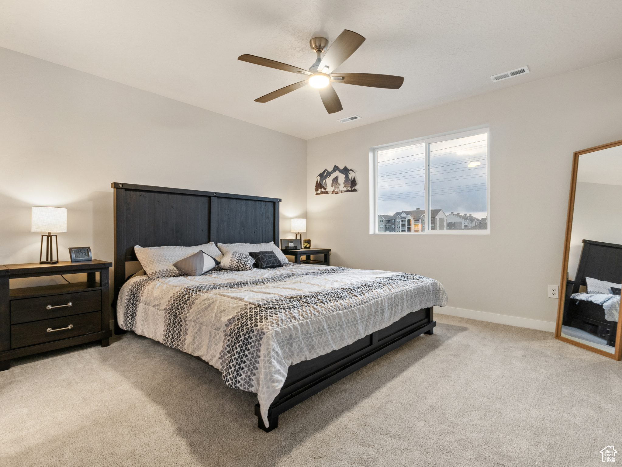 Carpeted bedroom with ceiling fan