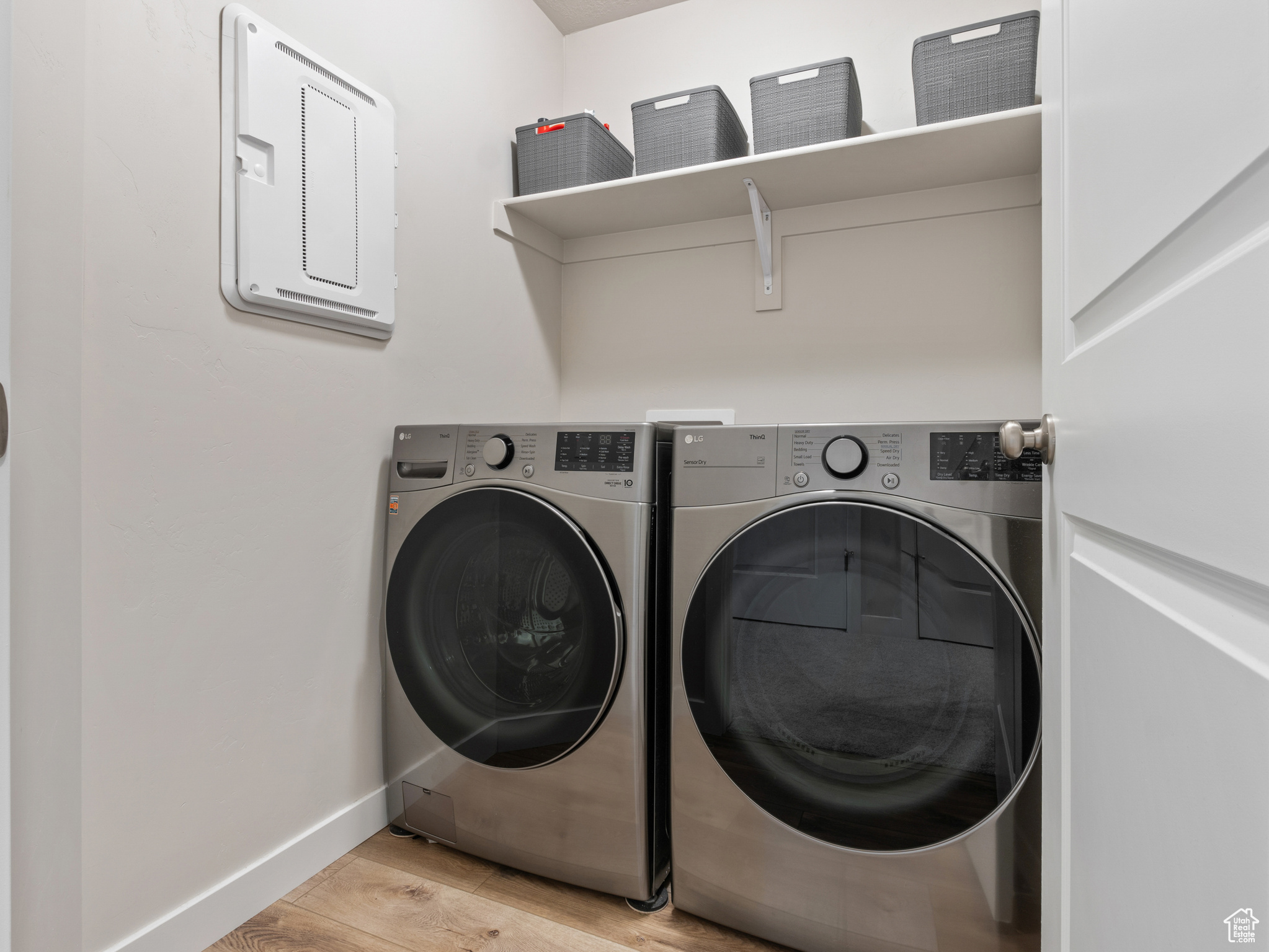 Laundry room featuring washer and dryer and light hardwood / wood-style floors