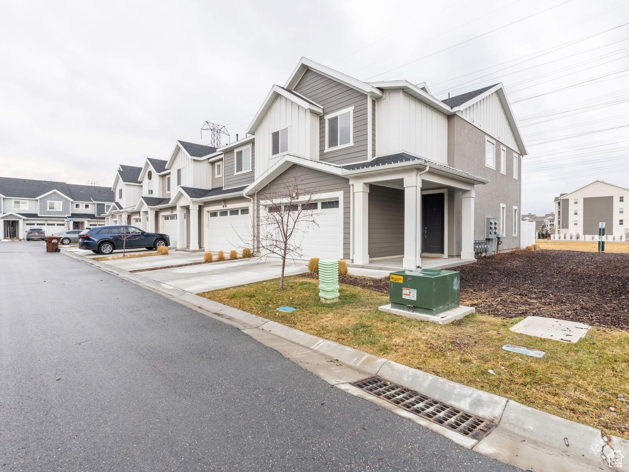 View of front of property featuring a garage and a front lawn