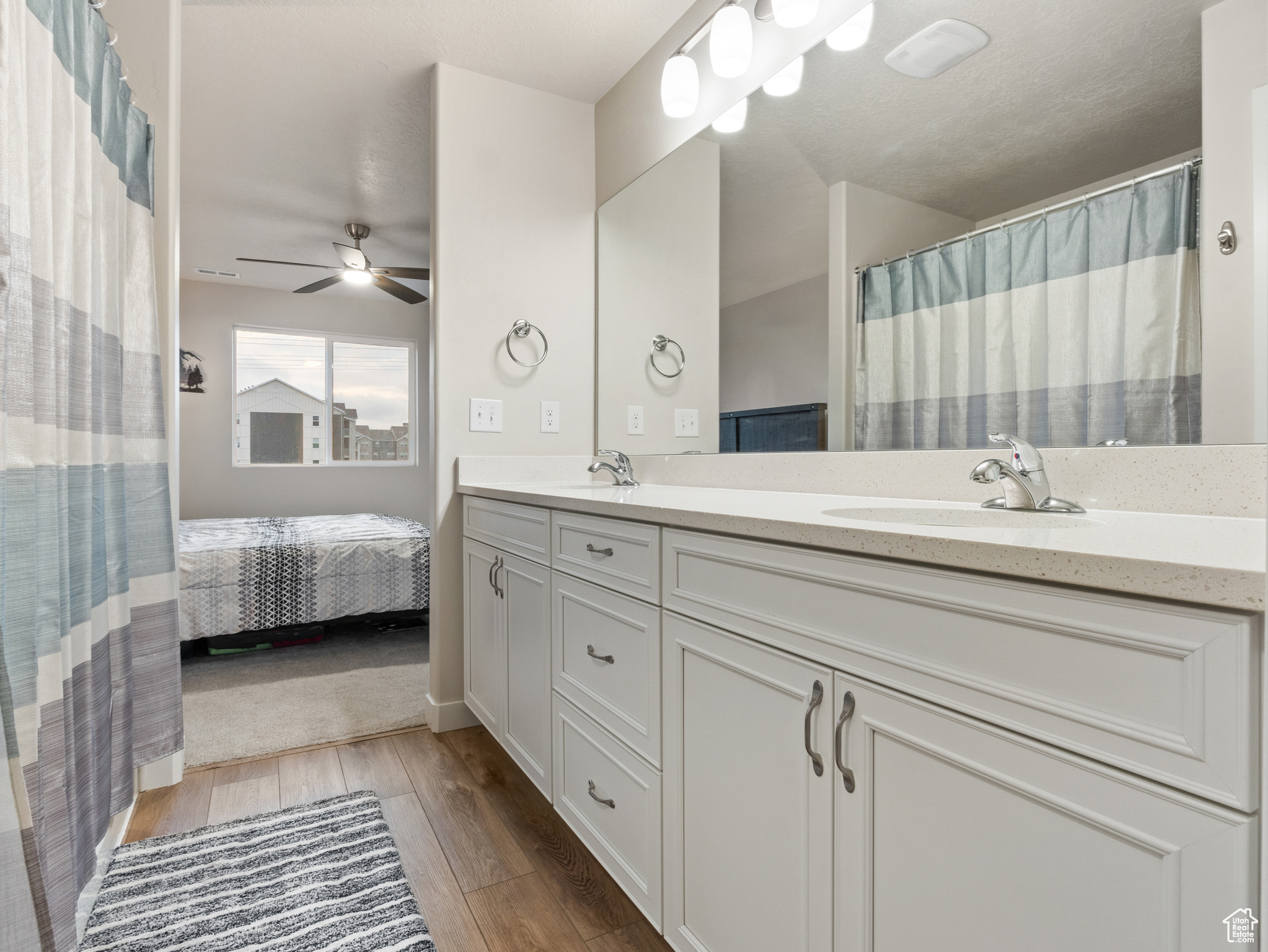 Bathroom featuring ceiling fan, hardwood / wood-style floors, and vanity