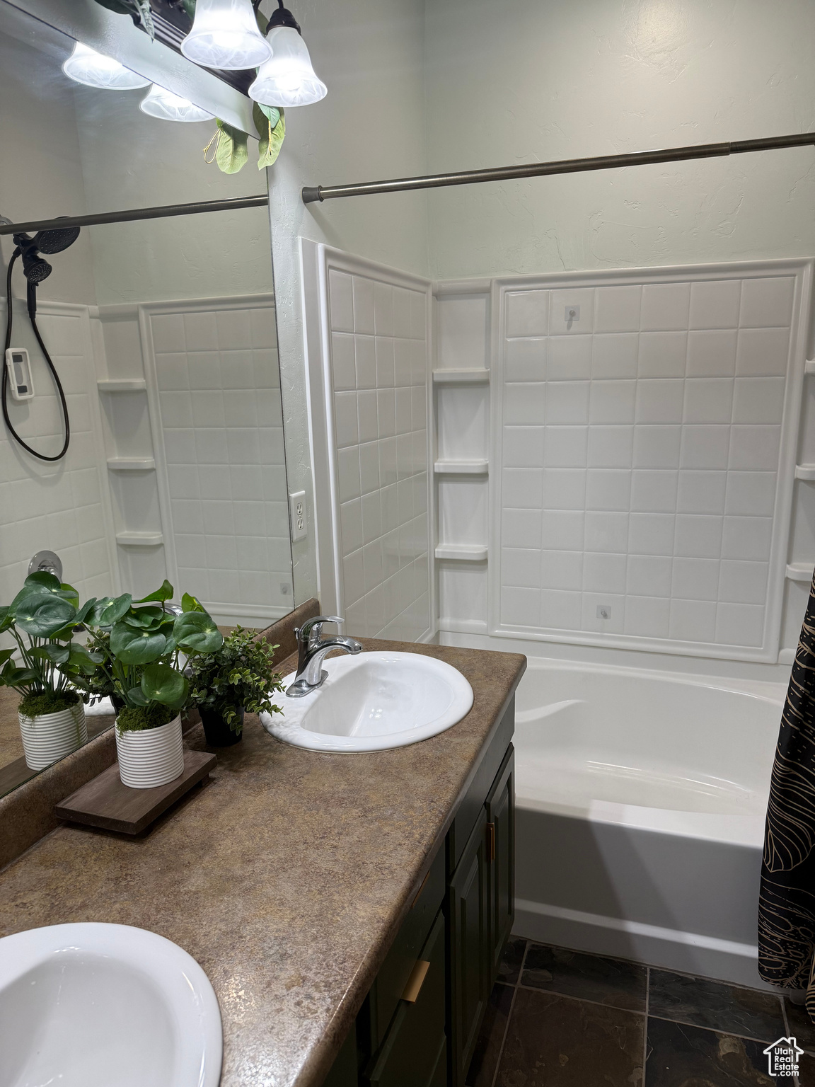 Bathroom with shower / tub combo and vanity