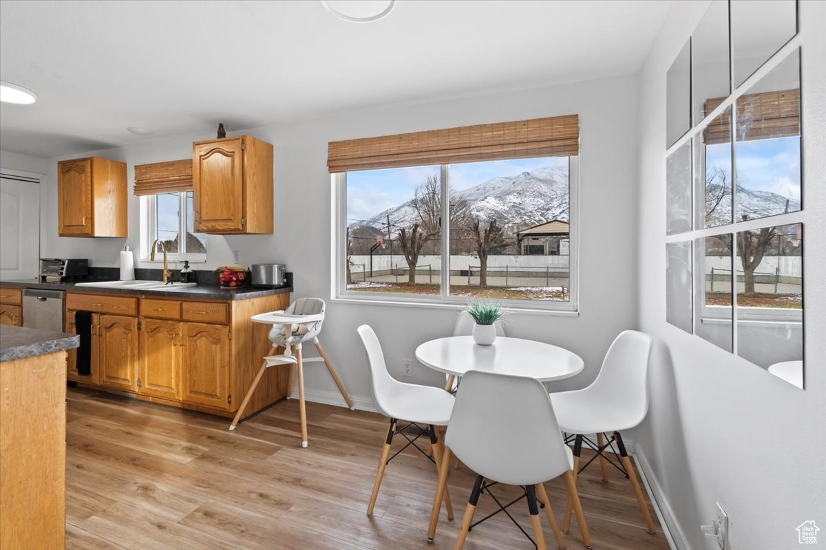 Dining room featuring a mountain view, light hardwood / wood-style floors, plenty of natural light, and sink