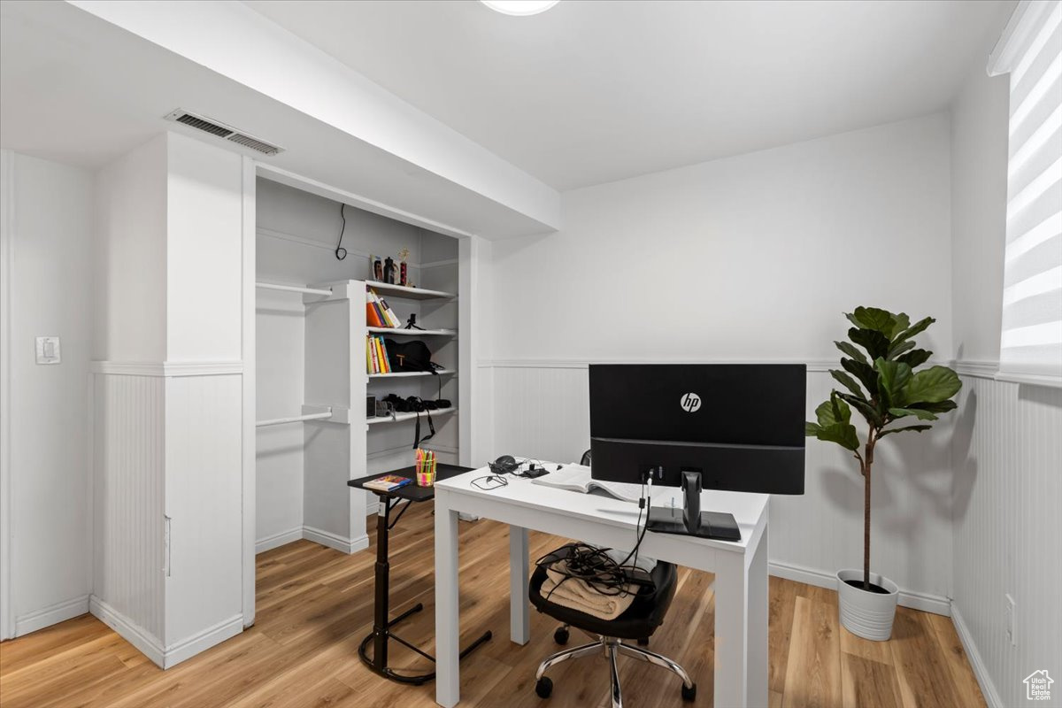 Office with hardwood / wood-style floors