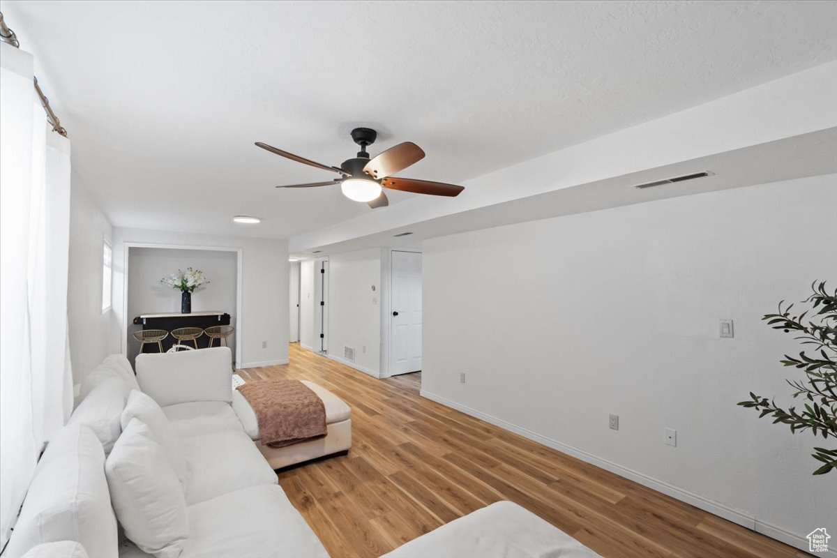 Living room featuring hardwood / wood-style floors and ceiling fan