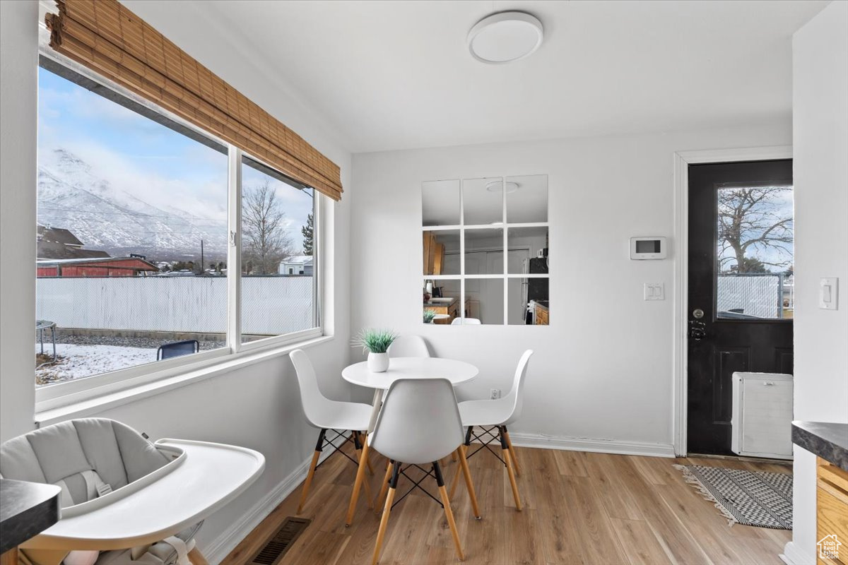 Dining room featuring plenty of natural light and light hardwood / wood-style floors