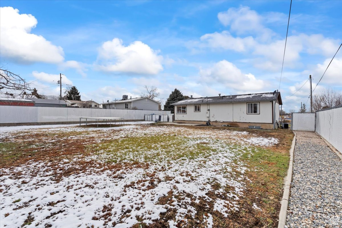 View of snow covered back of property