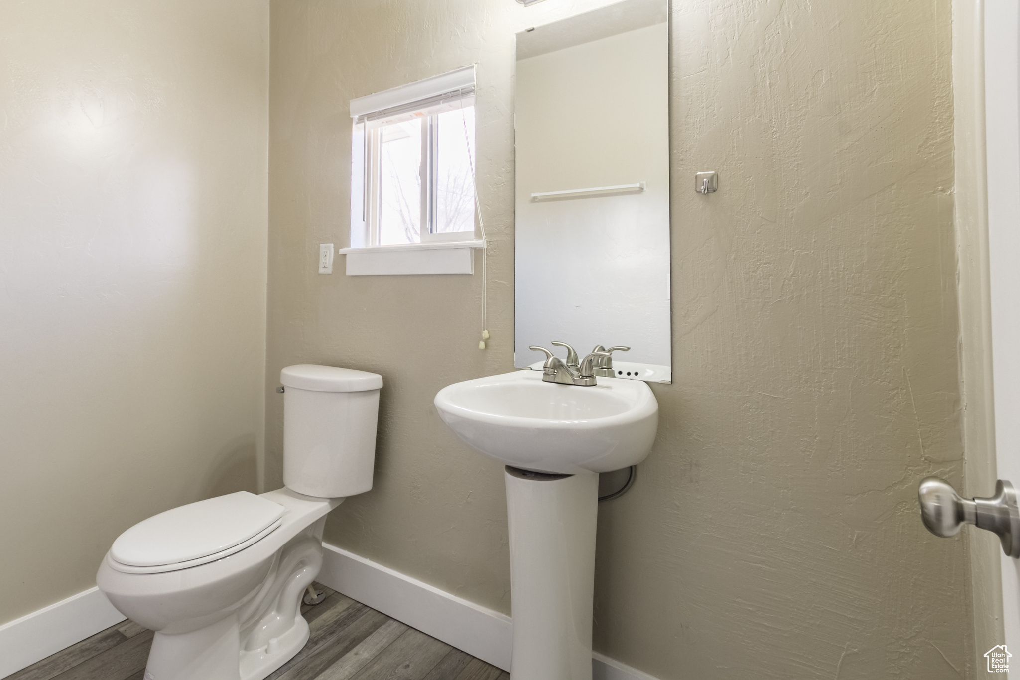 Bathroom featuring wood-type flooring and toilet