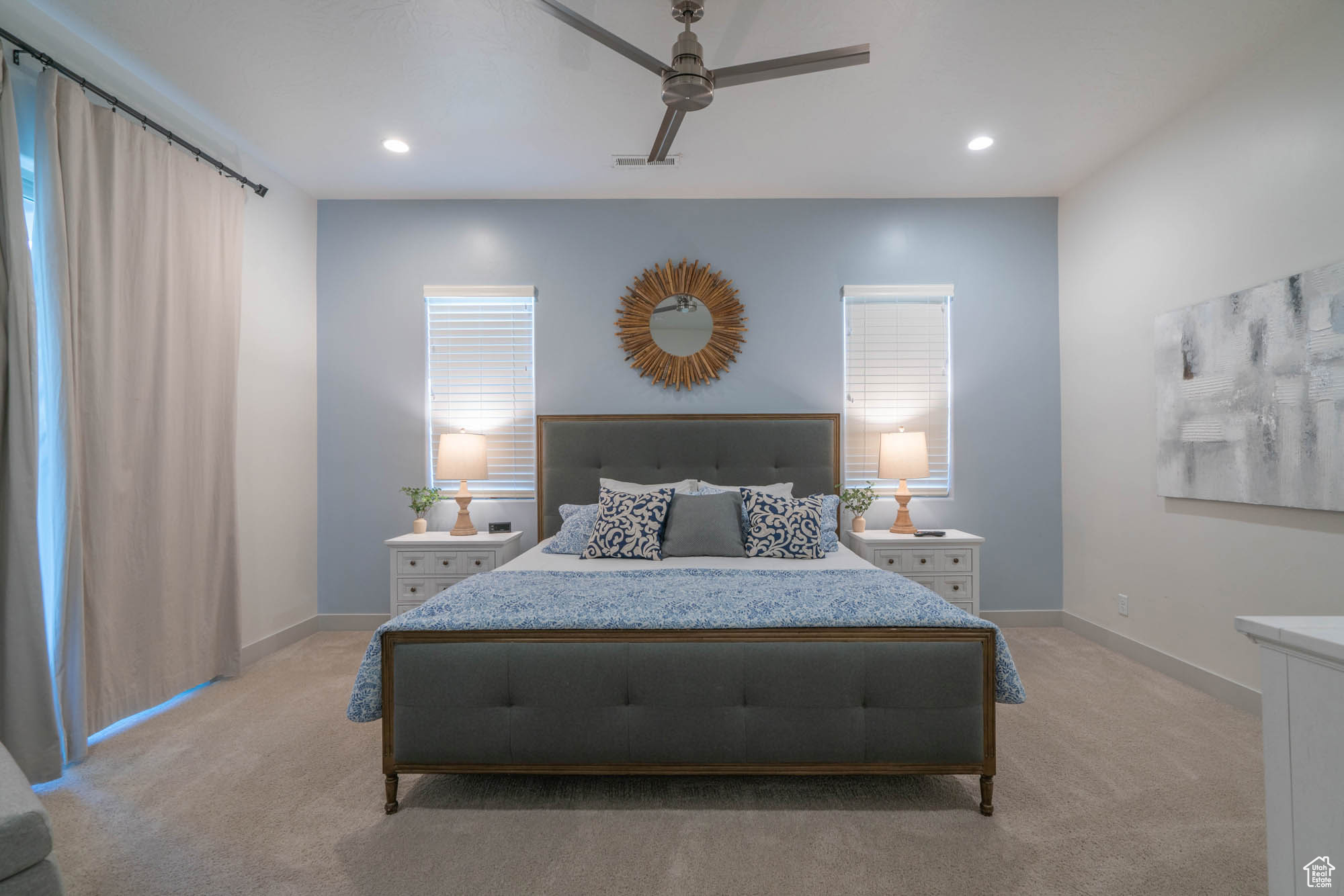 Bedroom with light colored carpet and ceiling fan