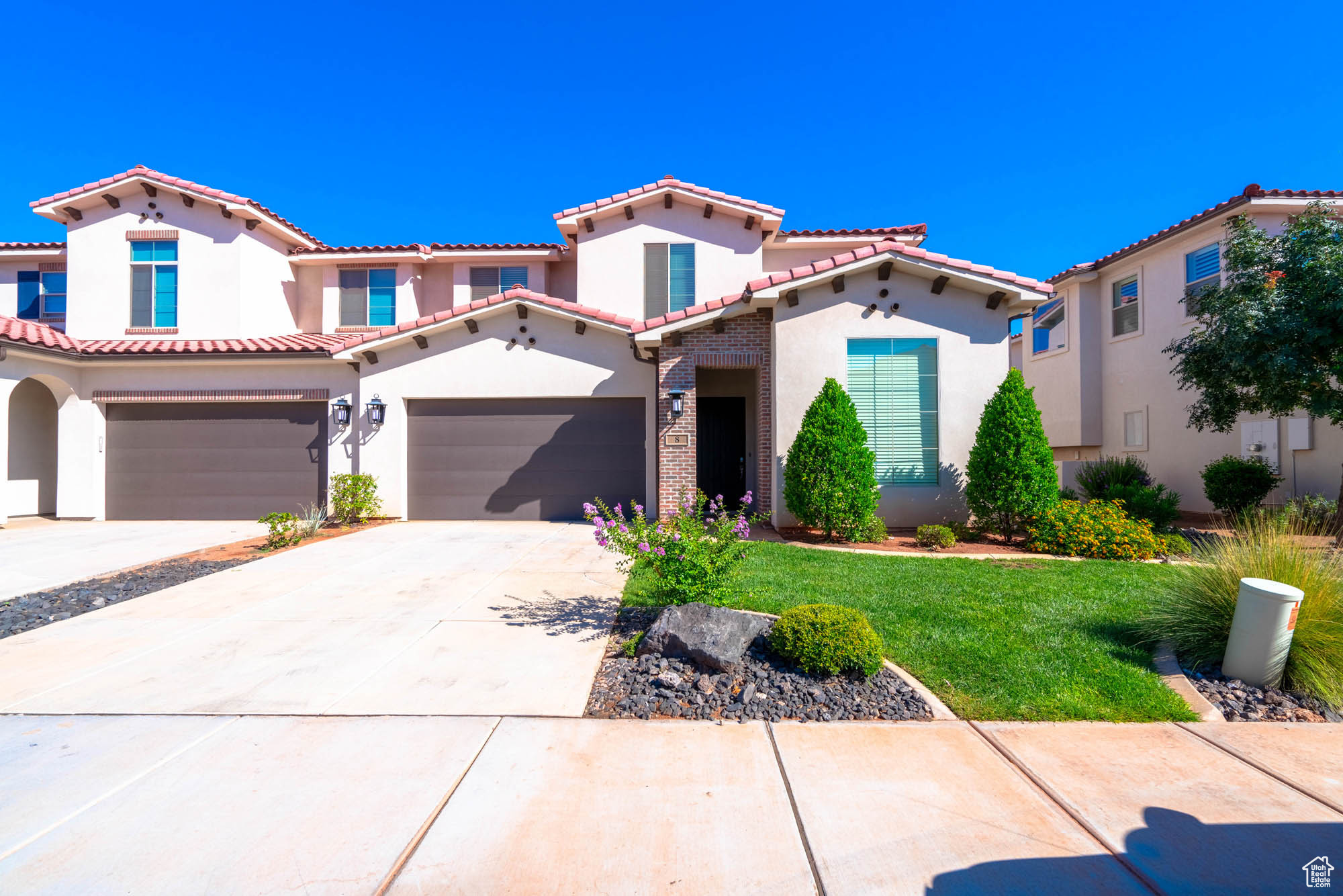 Mediterranean / spanish-style house featuring a front lawn and a garage