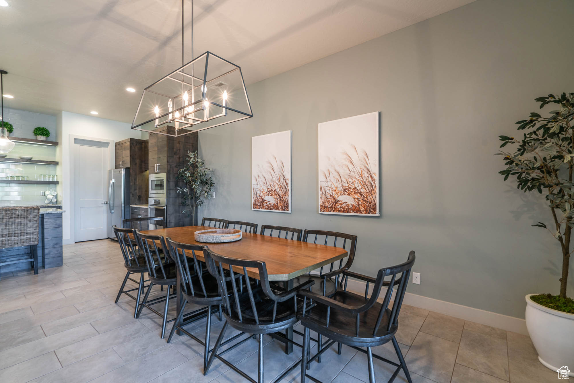 Tiled dining space featuring an inviting chandelier