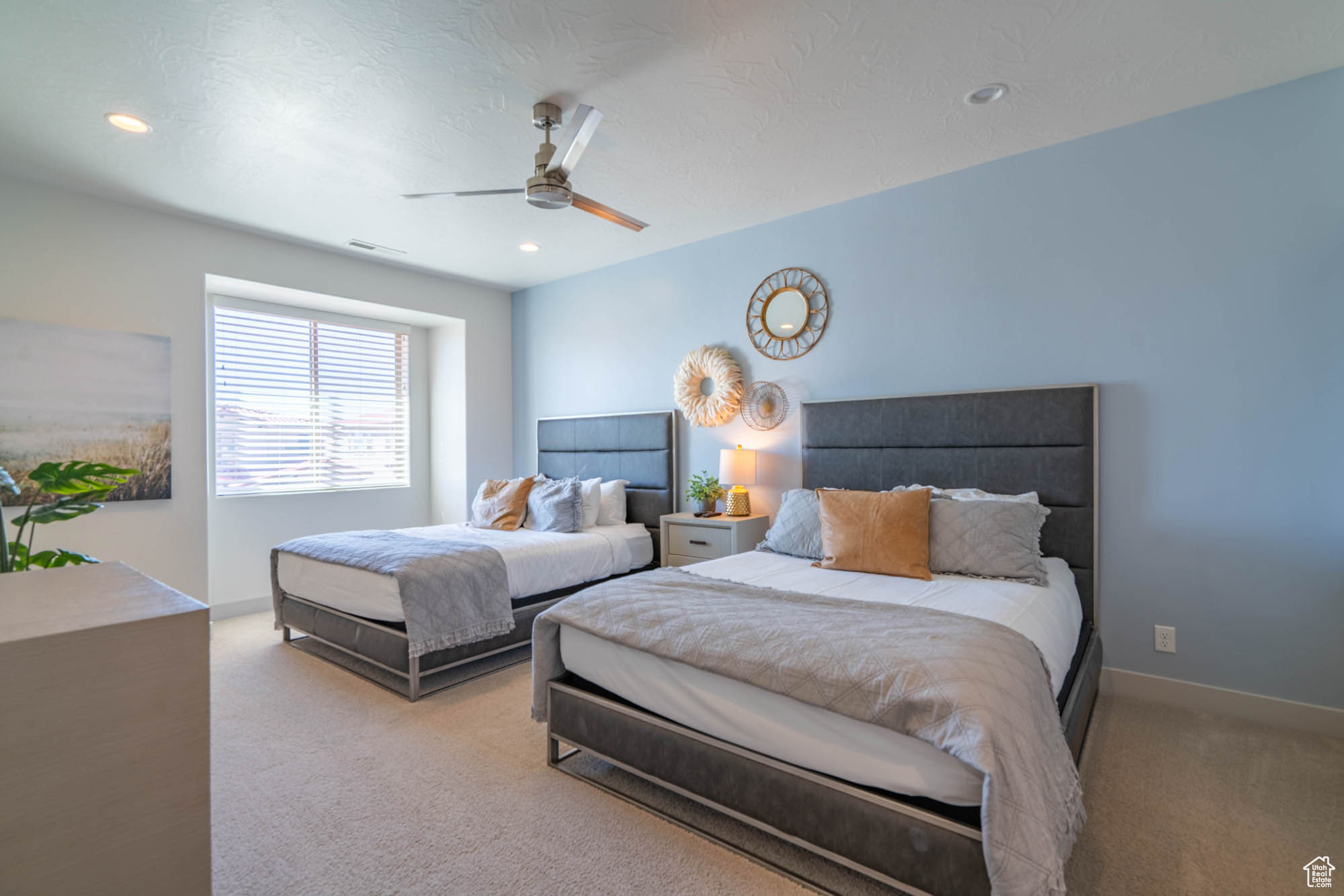 Bedroom with light colored carpet and ceiling fan