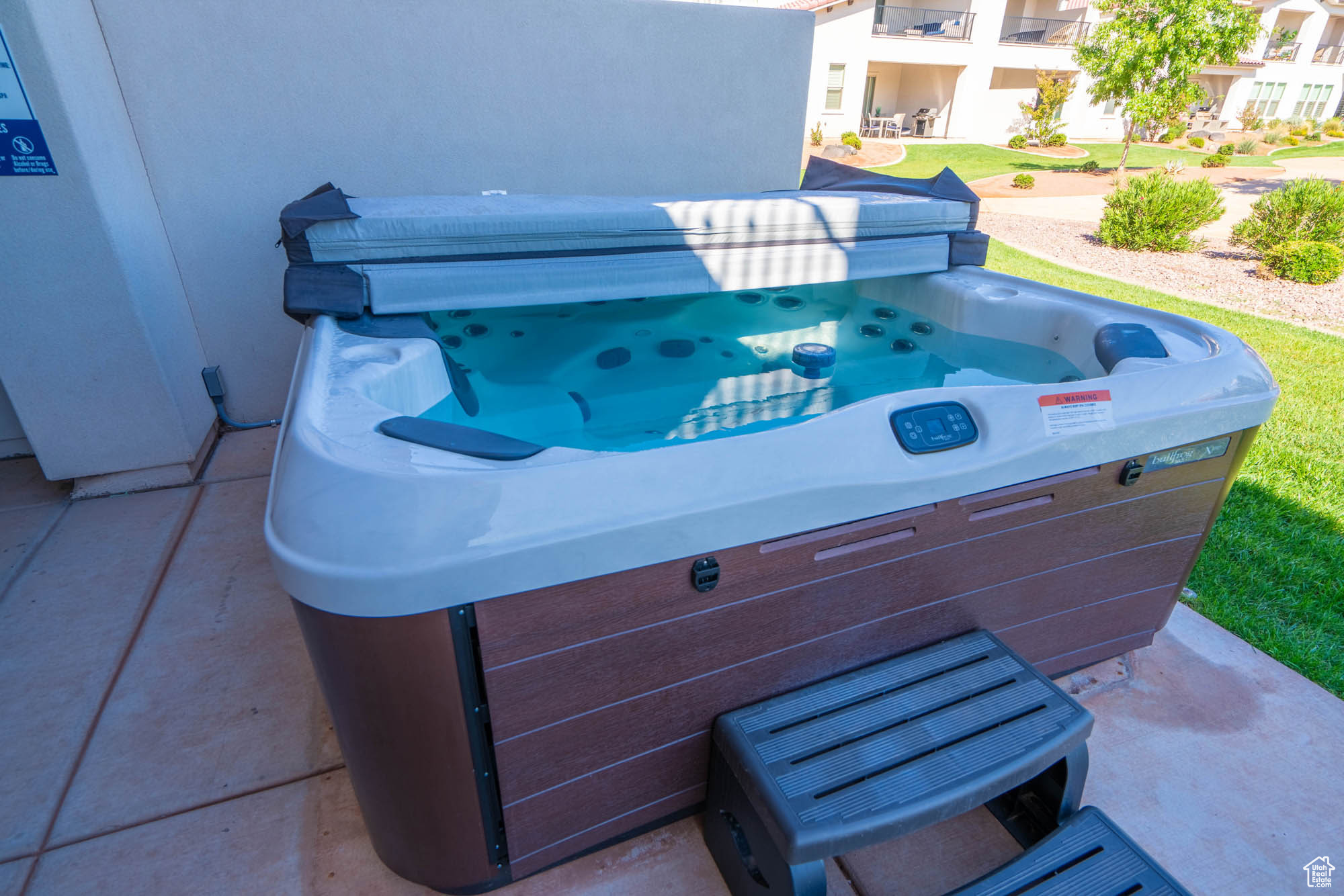 View of patio featuring a hot tub