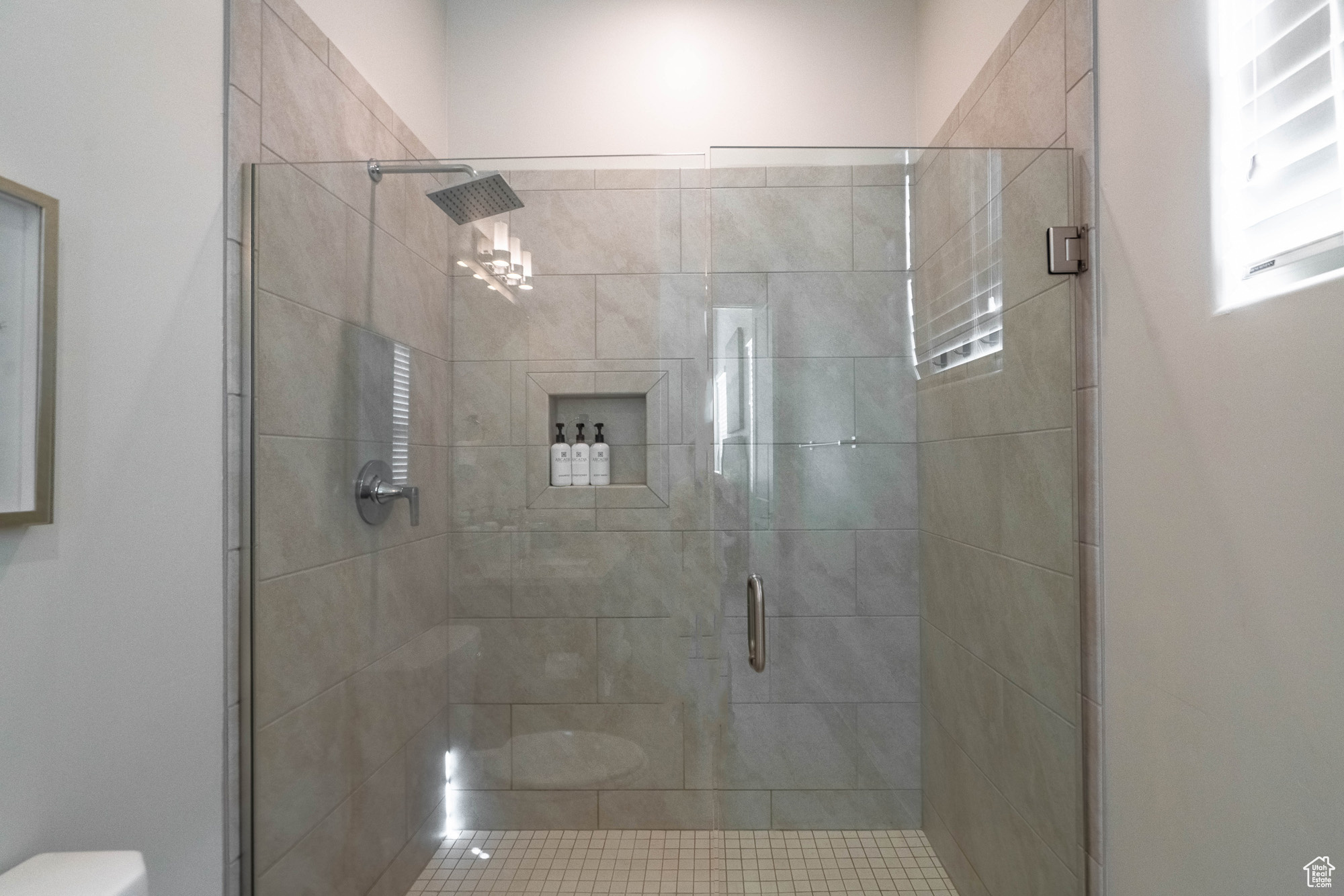 Bathroom with a shower with shower door