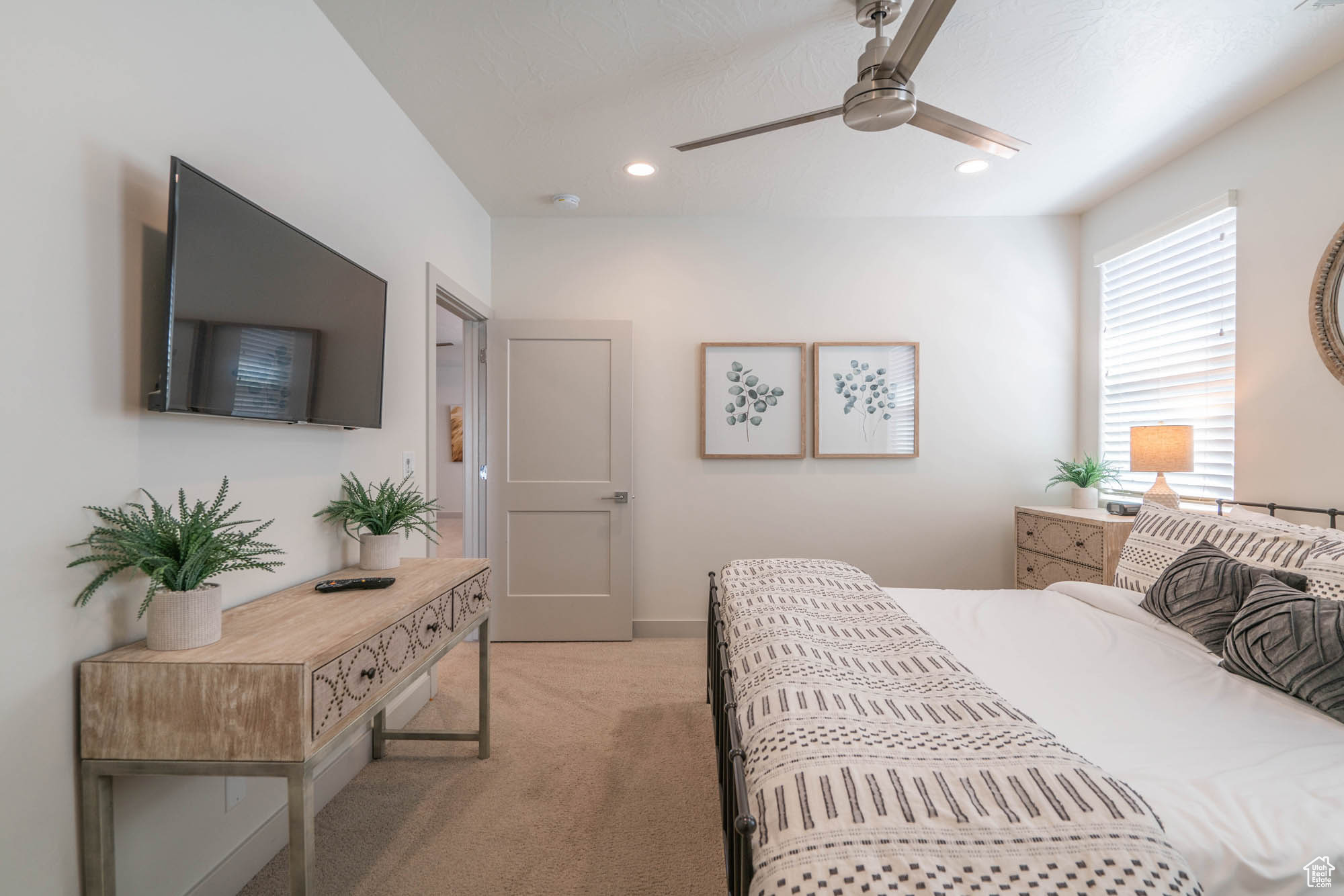 Bedroom featuring ceiling fan and light carpet