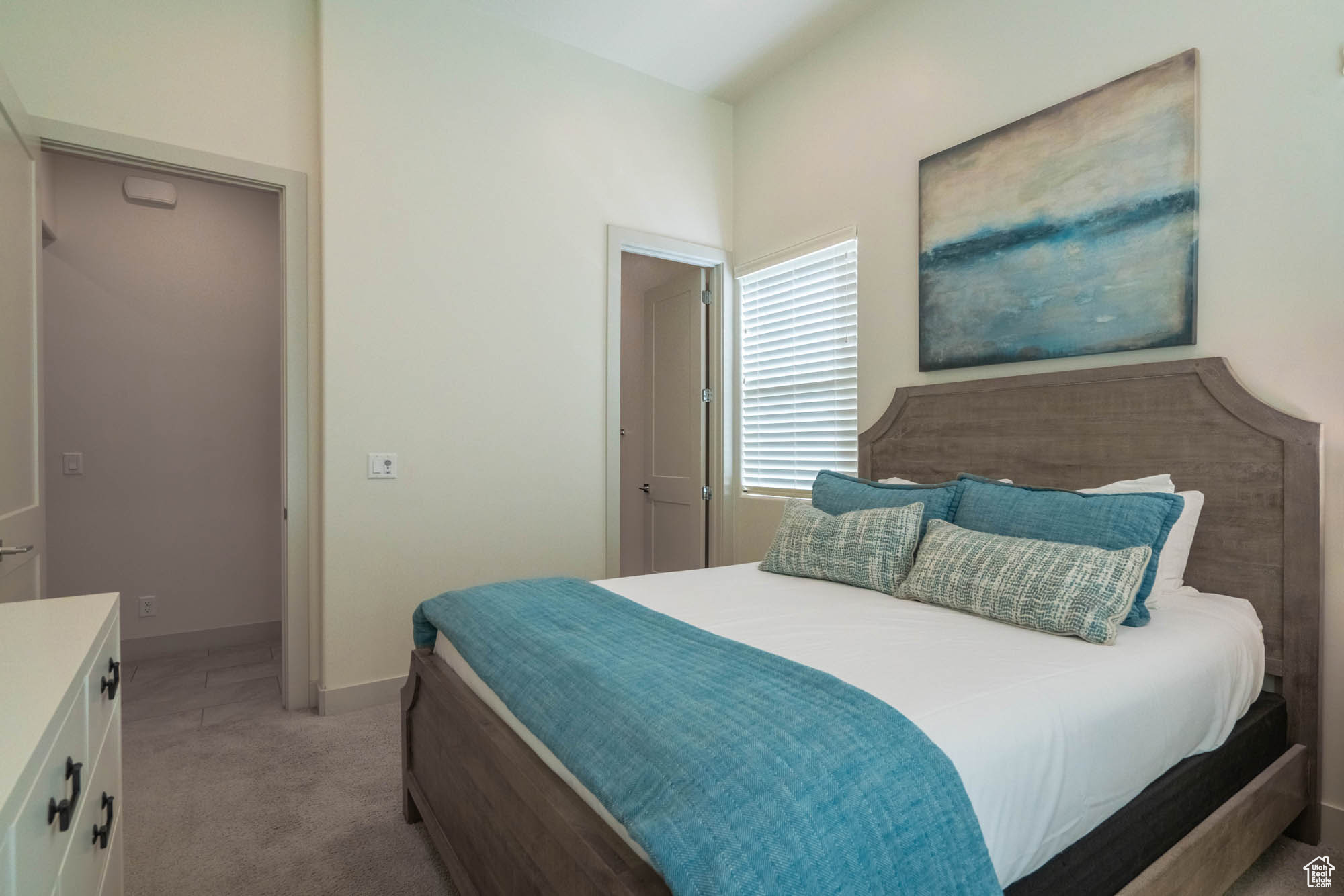 Bedroom featuring light colored carpet