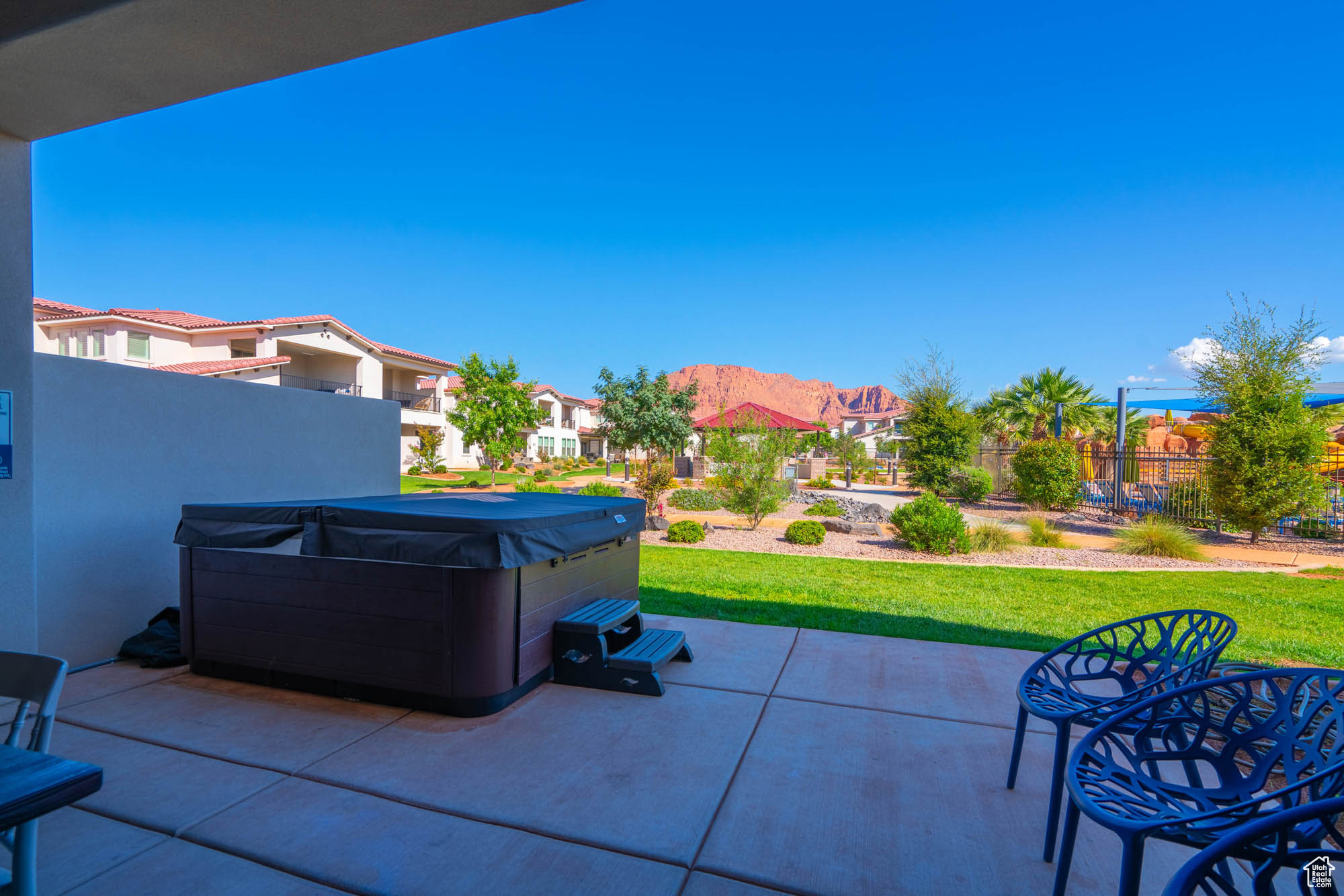 View of patio / terrace with a mountain view and a hot tub