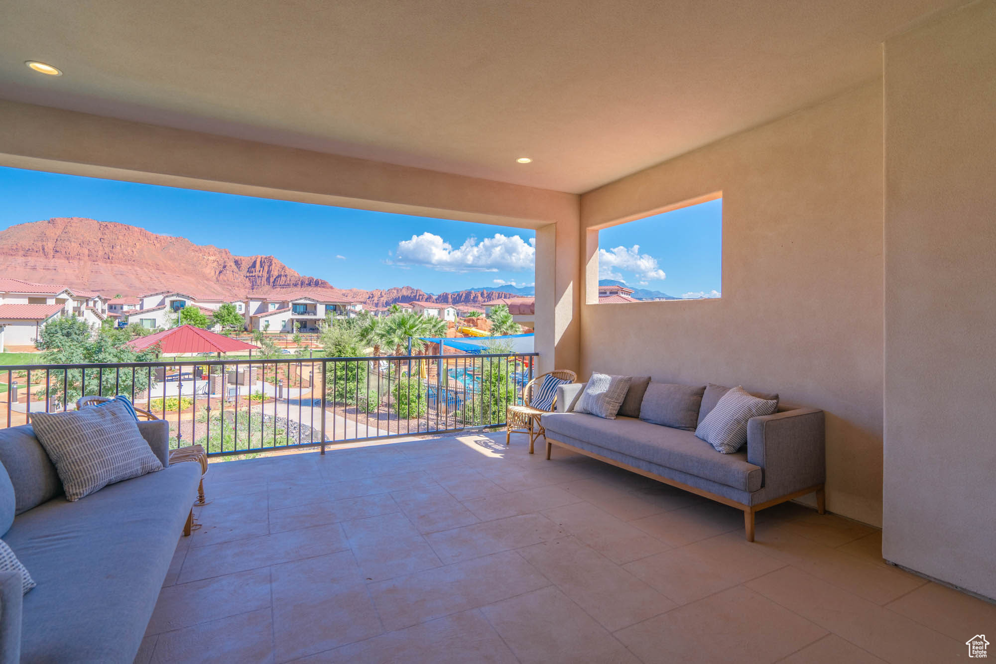 View of patio with a mountain view and a balcony