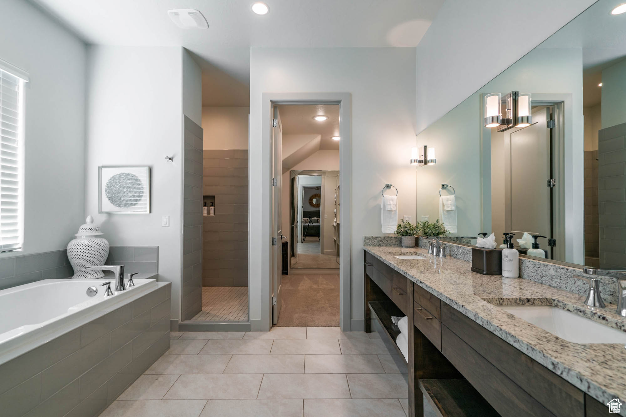 Bathroom with tile patterned flooring, vanity, and shower with separate bathtub