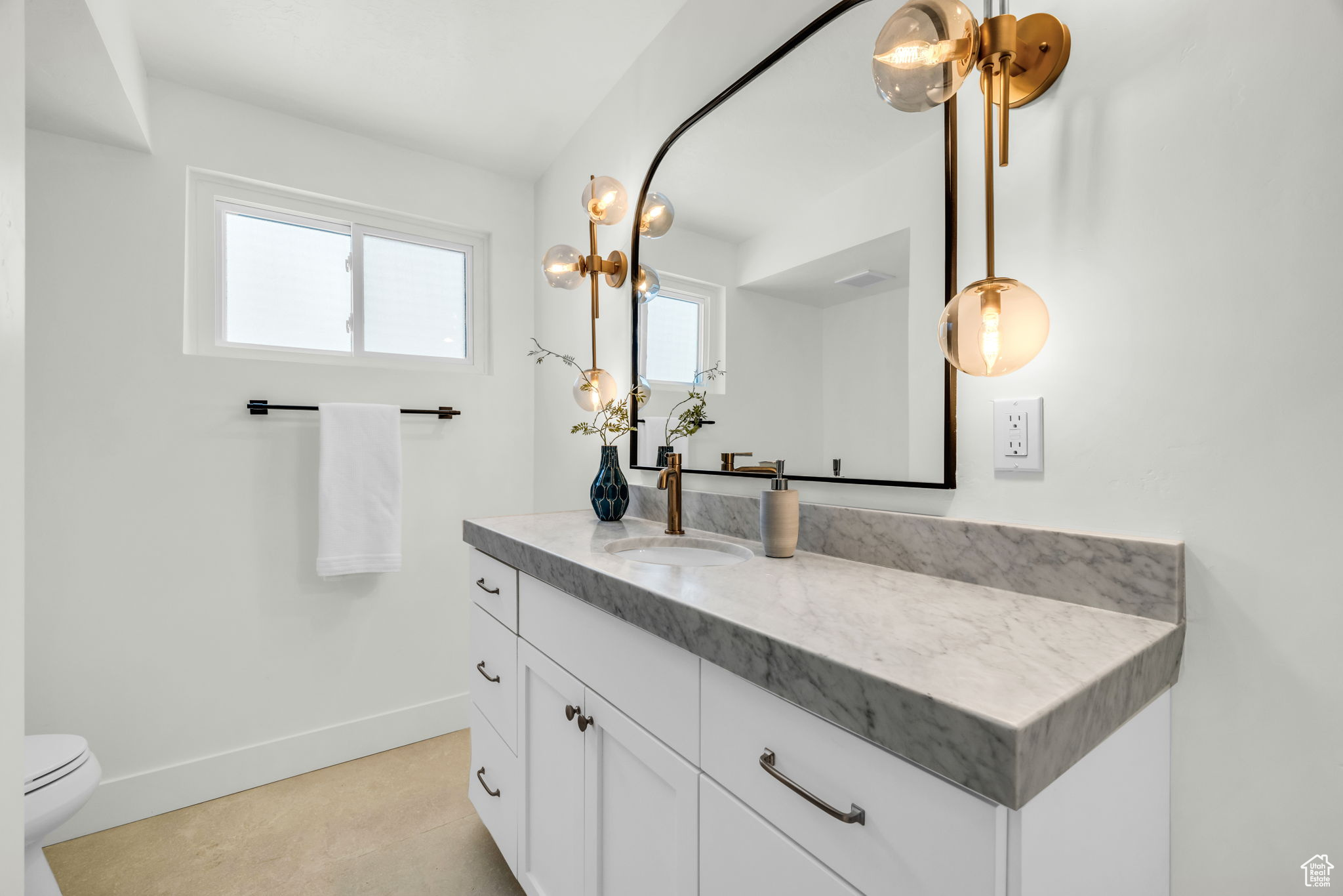 Bathroom with tile patterned flooring, vanity, and toilet