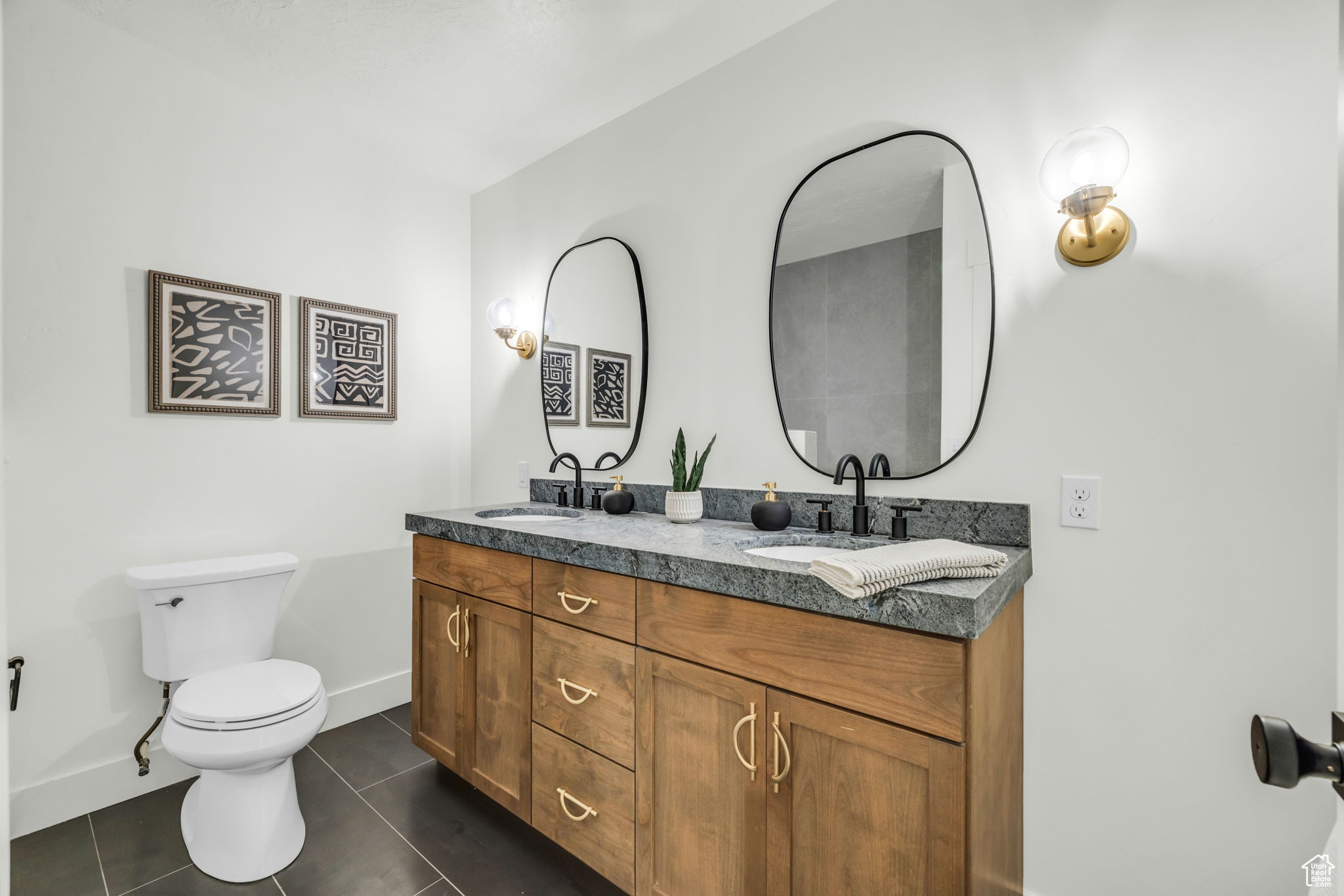 Bathroom featuring tile patterned floors, vanity, and toilet