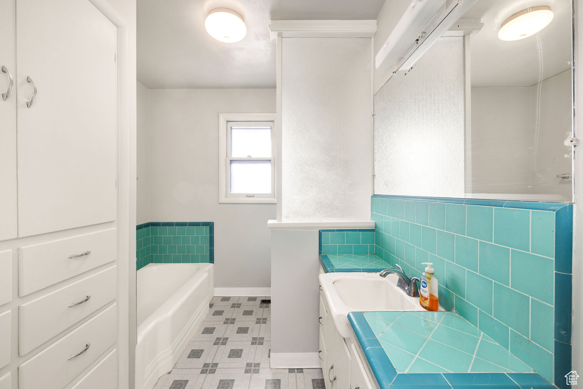 Bathroom with vanity and a bath