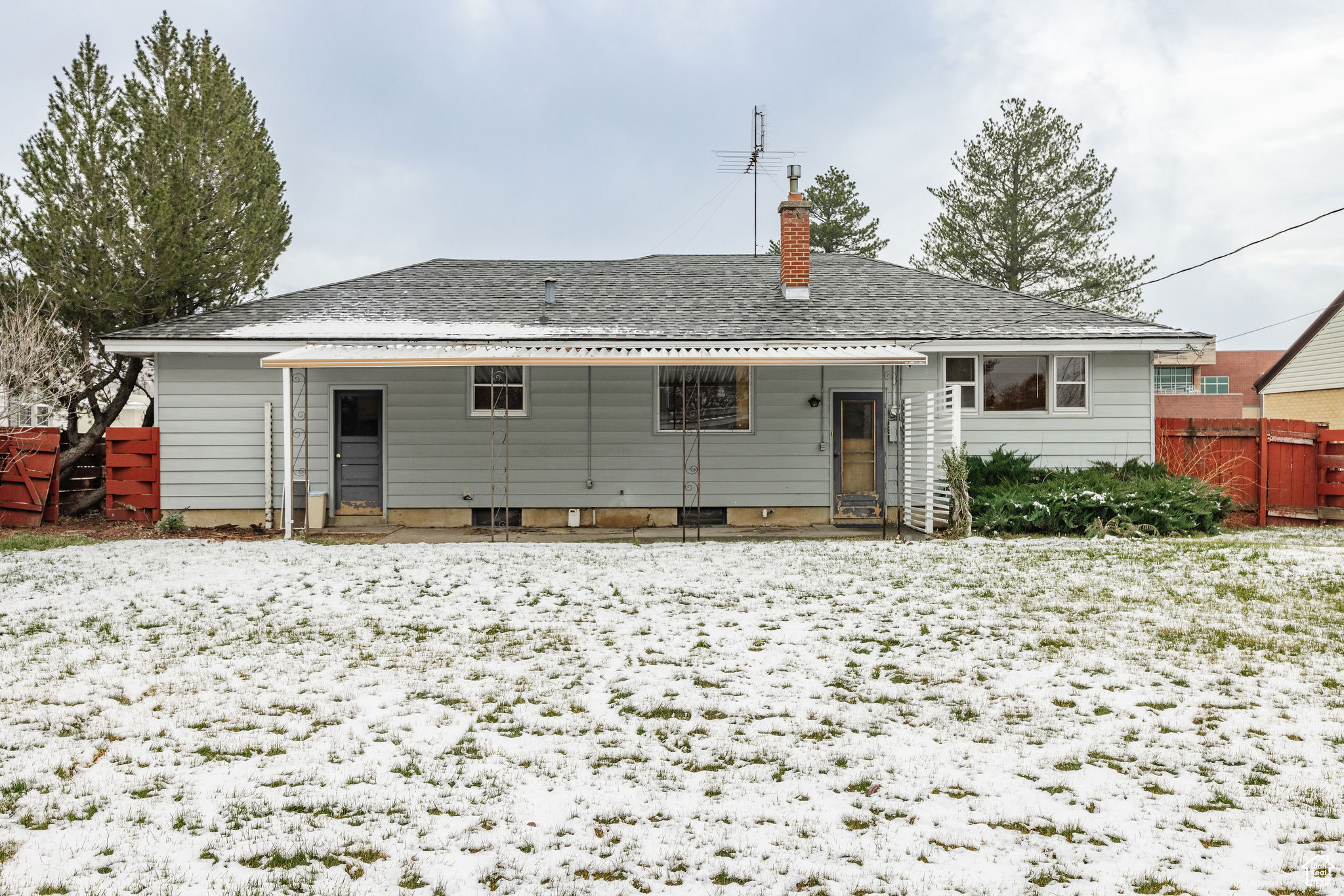 View of snow covered back of property